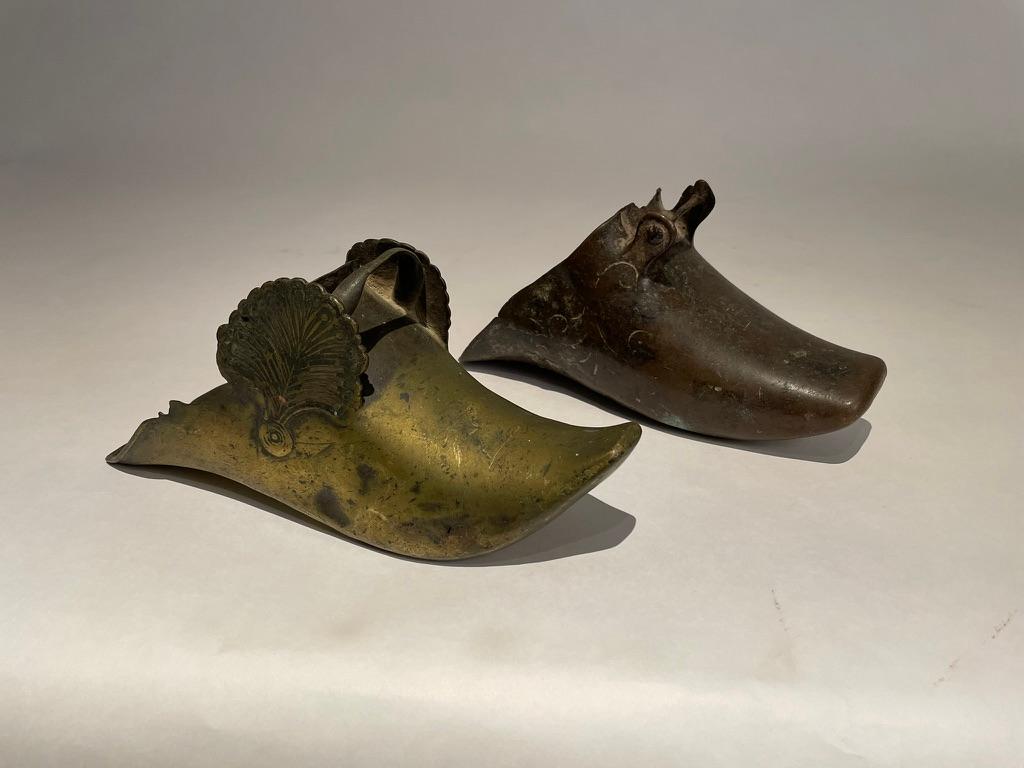 Two great examples of 18th century Spanish Colonial slipper stirrups. Not a pair, each similar yet different. One is brass with a lovely floral decoration, the other a rare copper type with a simple incised design. Both with a wonderful patina that