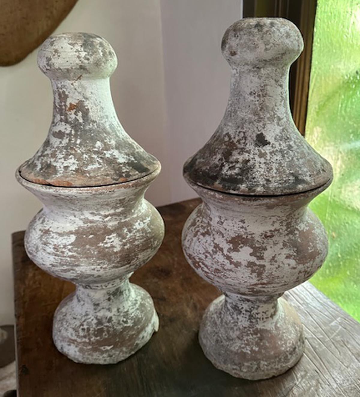 This listing is for two 19th century terra-cotta finials with old gesso. These sat on pre 1825, Spanish Colonial houses. Top lifts off. From the high Highlands of Guatemala. Old natural patina
