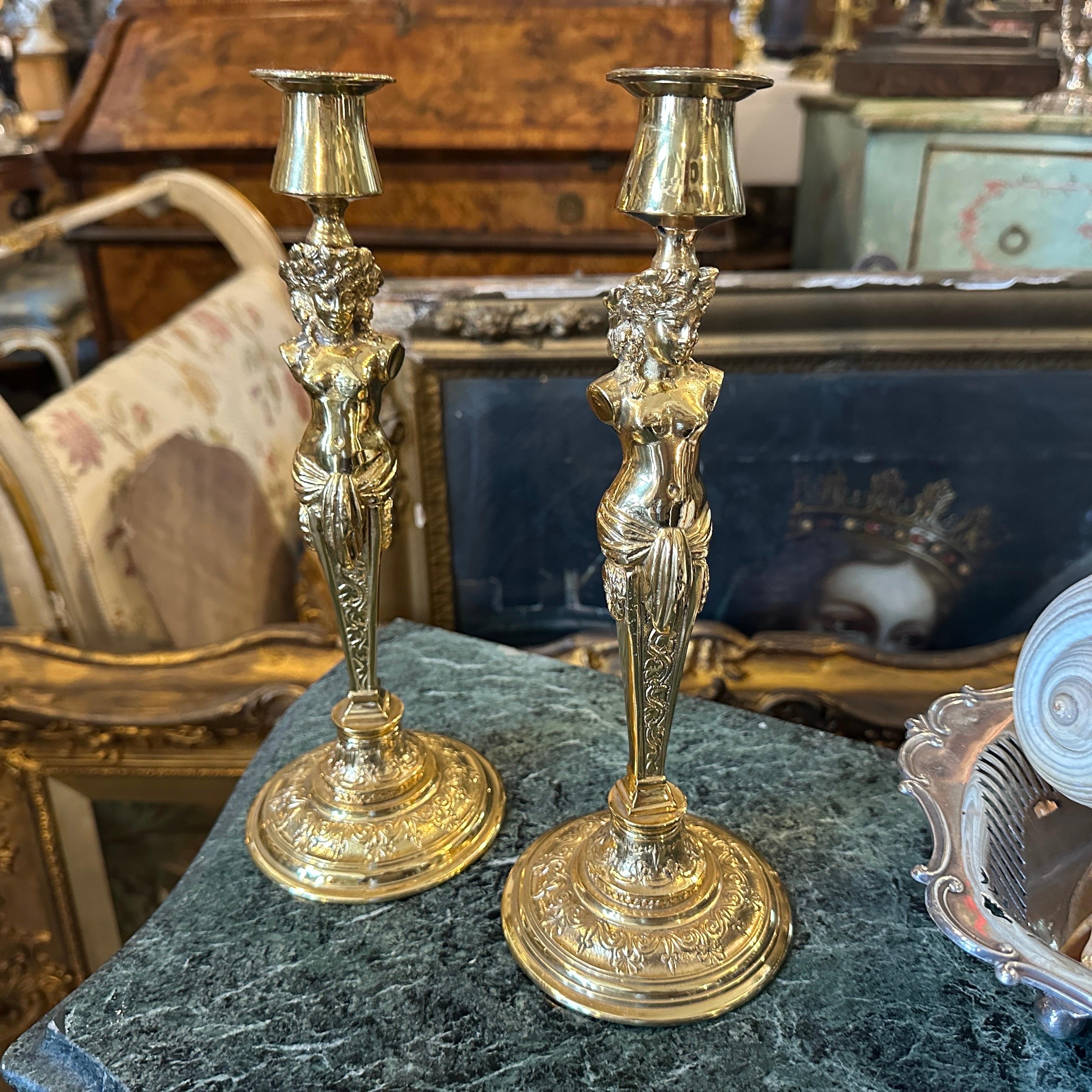 A stunning pair of Italian Art Nouveau candlesticks, crafted from beautifully gilded metal in the mid 20th century. These elegant pieces capture the quintessential grace and flowing lines of the Art Nouveau movement, making them a captivating