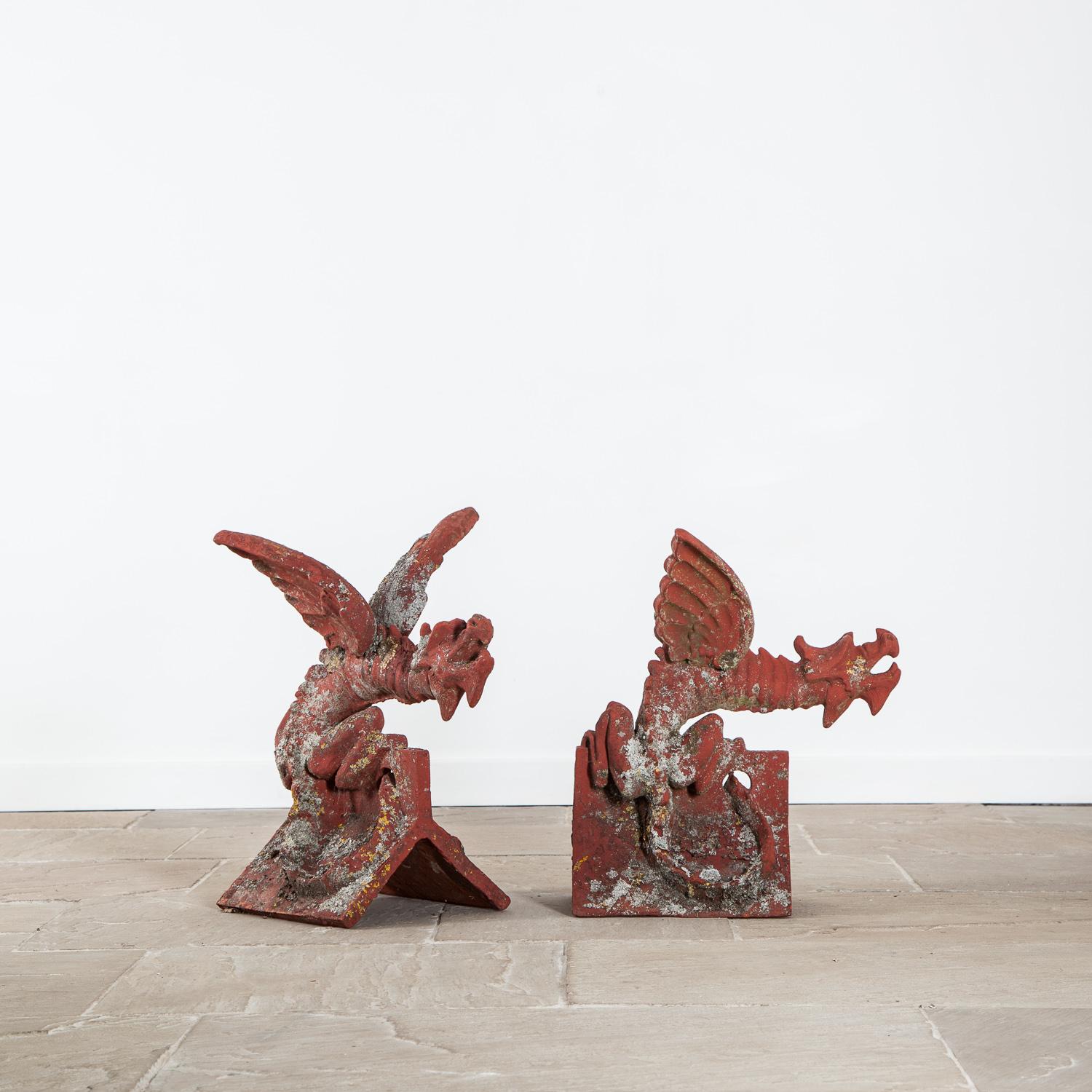 Two handmade painted terracotta ridge tiles in the form of Dragons, mid-late 20th century.

Made by the renowned Keymer Company from Suffolk est.1588, stamped to the underside. 

Dragon one measurements approximately height 60cm x width 45cm x depth