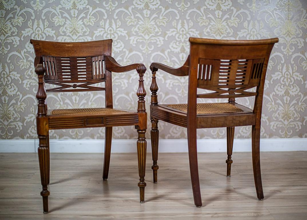 Two 20th-Century Walnut Rattan Armchairs

We present you a pair of walnut armchairs from Q1 of the 20th century.
The furniture has fluted front legs and the rails are finished with volutes.
Furthermore, the backrests are slightly rolled outwards.