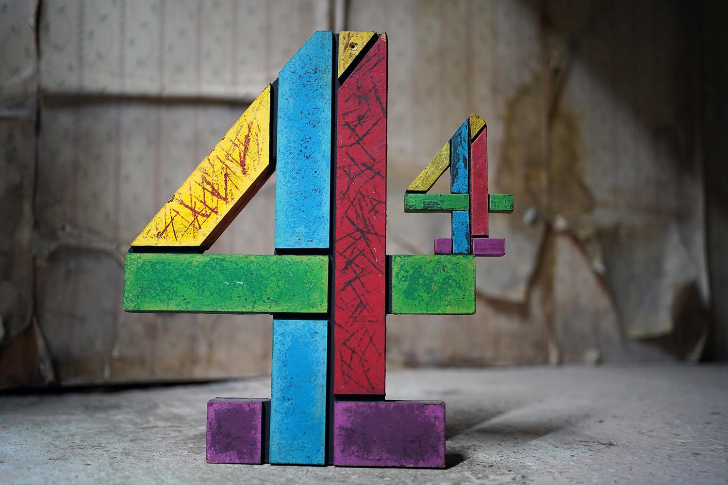 The on-screen used production channel 4 multi-coloured block segmented prop logos, one large and one small, as used in the channels idents in the mid-1990s, each being of wooden construction and made to appear as if they are of separate pieces,