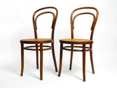 Two 30s coffee house chairs made of bentwood with cane weave by ZPM Radomsko