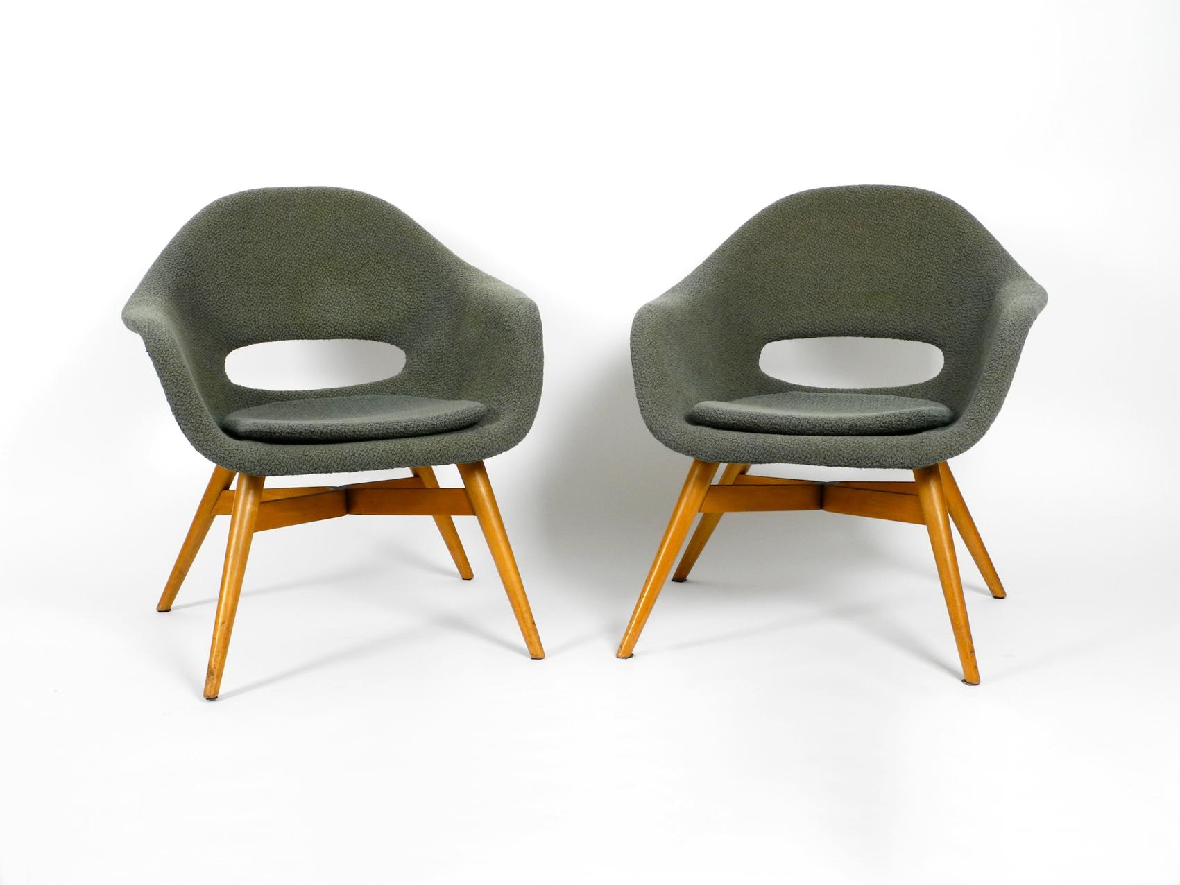 Pair of rare Mid-Century Modern 1960s lounge chairs by Miroslav Navratil with 
fiberglass shell and original cover. A classic Made in the Czech Republic.
Frame made of solid wood and plywood. Very high quality manufactured. 
Very good seating
