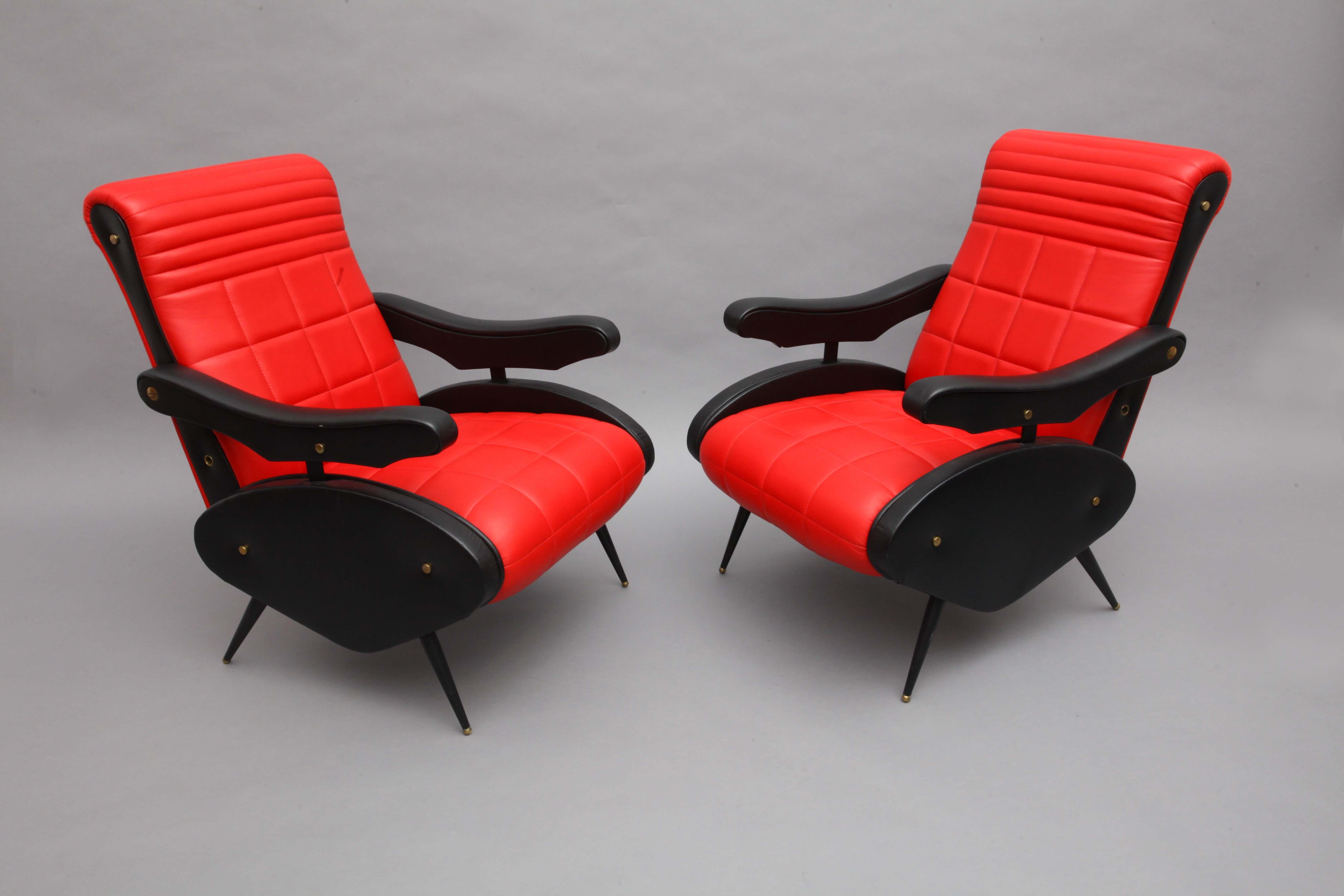 Two armchairs,
Style of Marco Zanuso,
Italy, 1958.
Adjustable armchairs,
black and red leather, 
black legs with brass shoes.