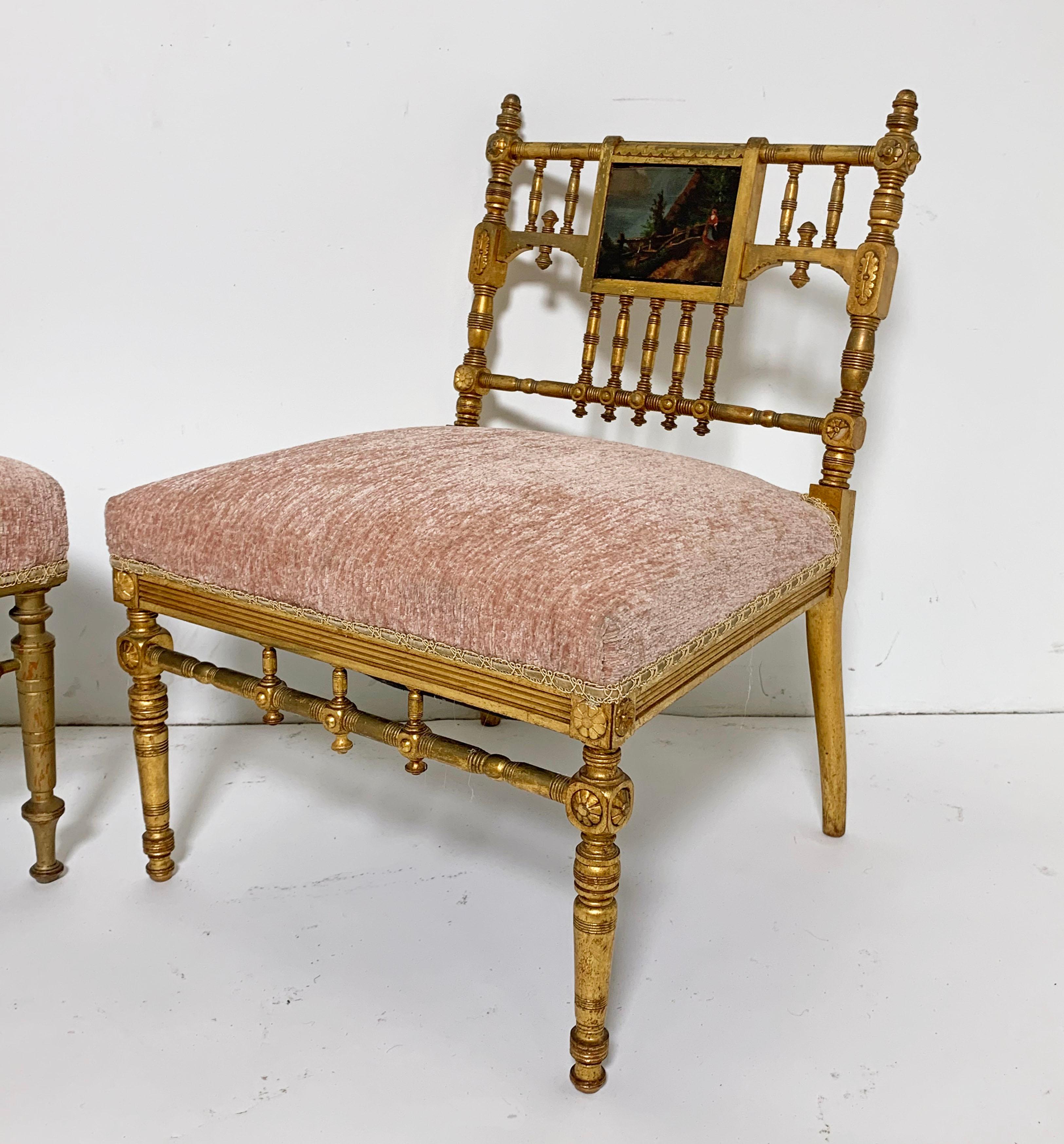 Two American Aesthetic Movement giltwood slipper chairs, most likely by Herter Brothers of New York. The carved giltwood frames consist of turned posts and finials with slight variations in the fretwork adding to their individual appeal. Both