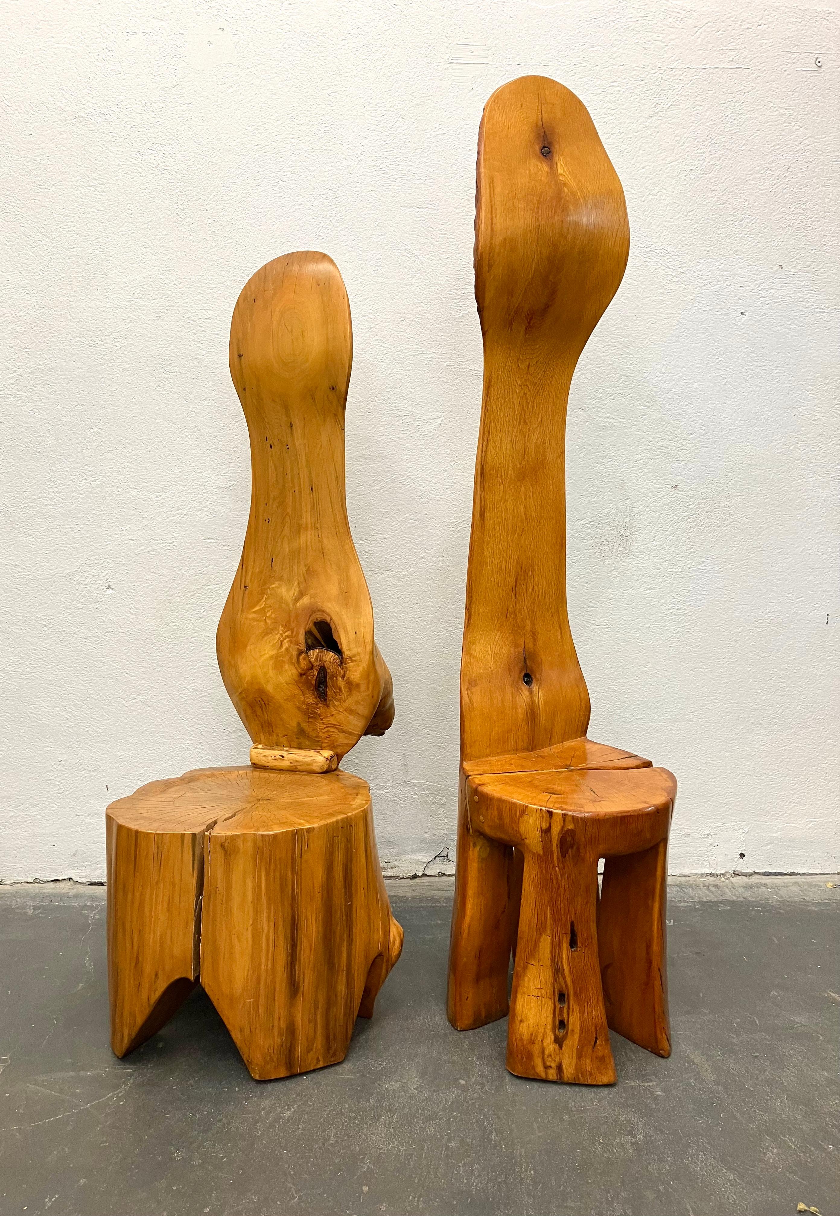 Artisan chairs circa 1960s, in the style of JB Blunk, one carved from a single redwood log, the other from a Cypress log, the taller redwood chair is initialed JB on the leg, with wonderful chip carved decoration on the back. Both are expertly