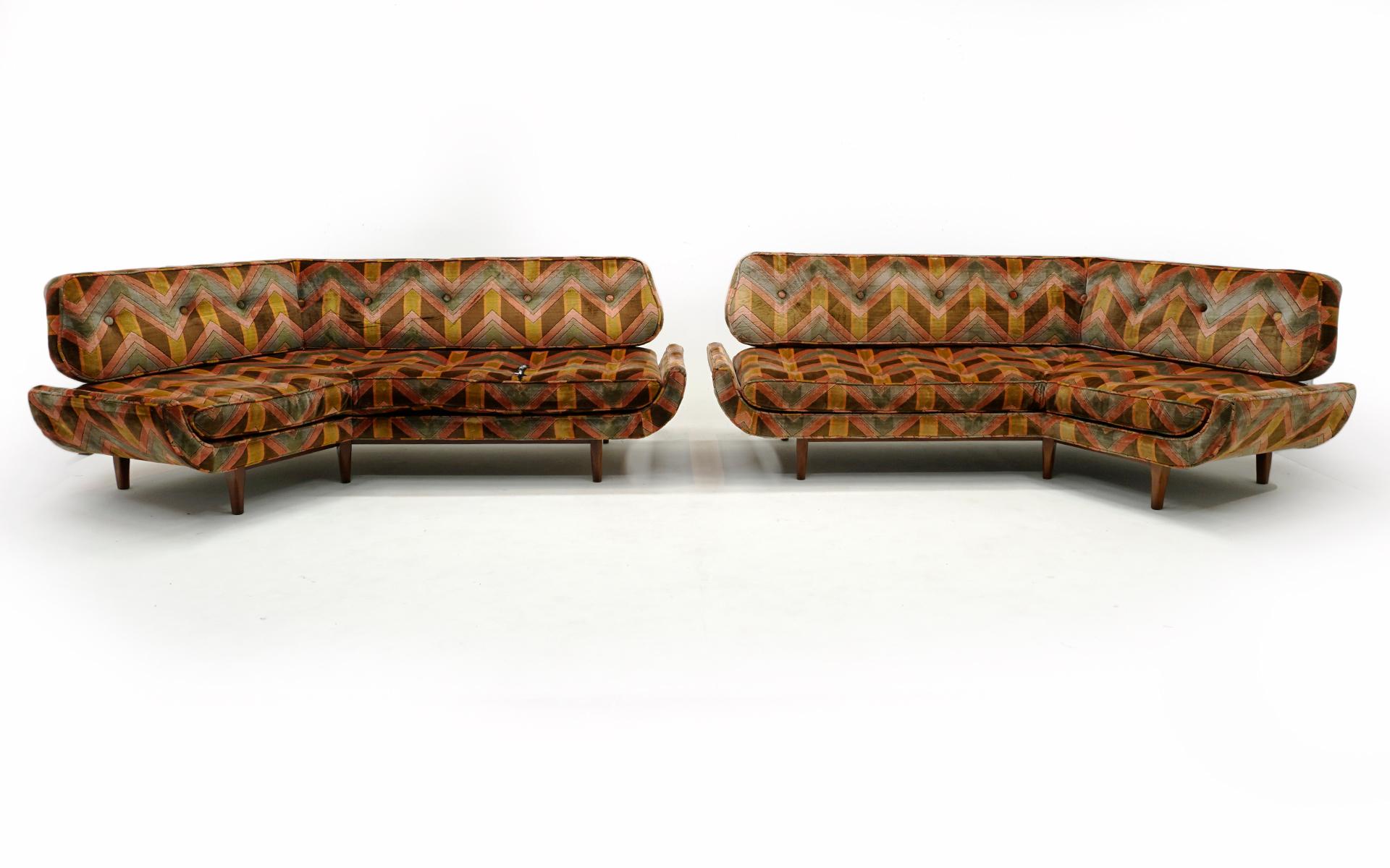 Pair of mirror image angled sofas by Dux, Sweden.  These one of a kind pieces were custom made for a residence in the 1960s,  Great mid century look and very comfortable.  When measuring from the angle point of the sofa to the ends, the shorter side