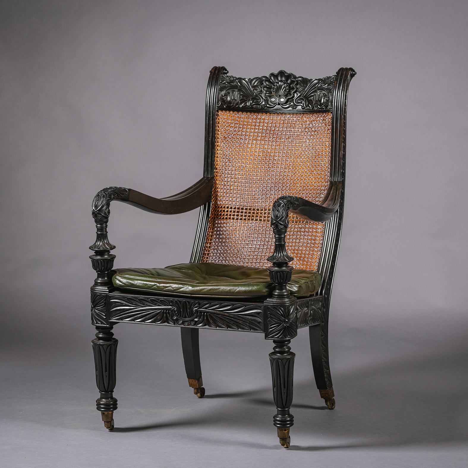 Sri Lankan Two Anglo-Indian Carved Ebony Easy Armchairs For Sale