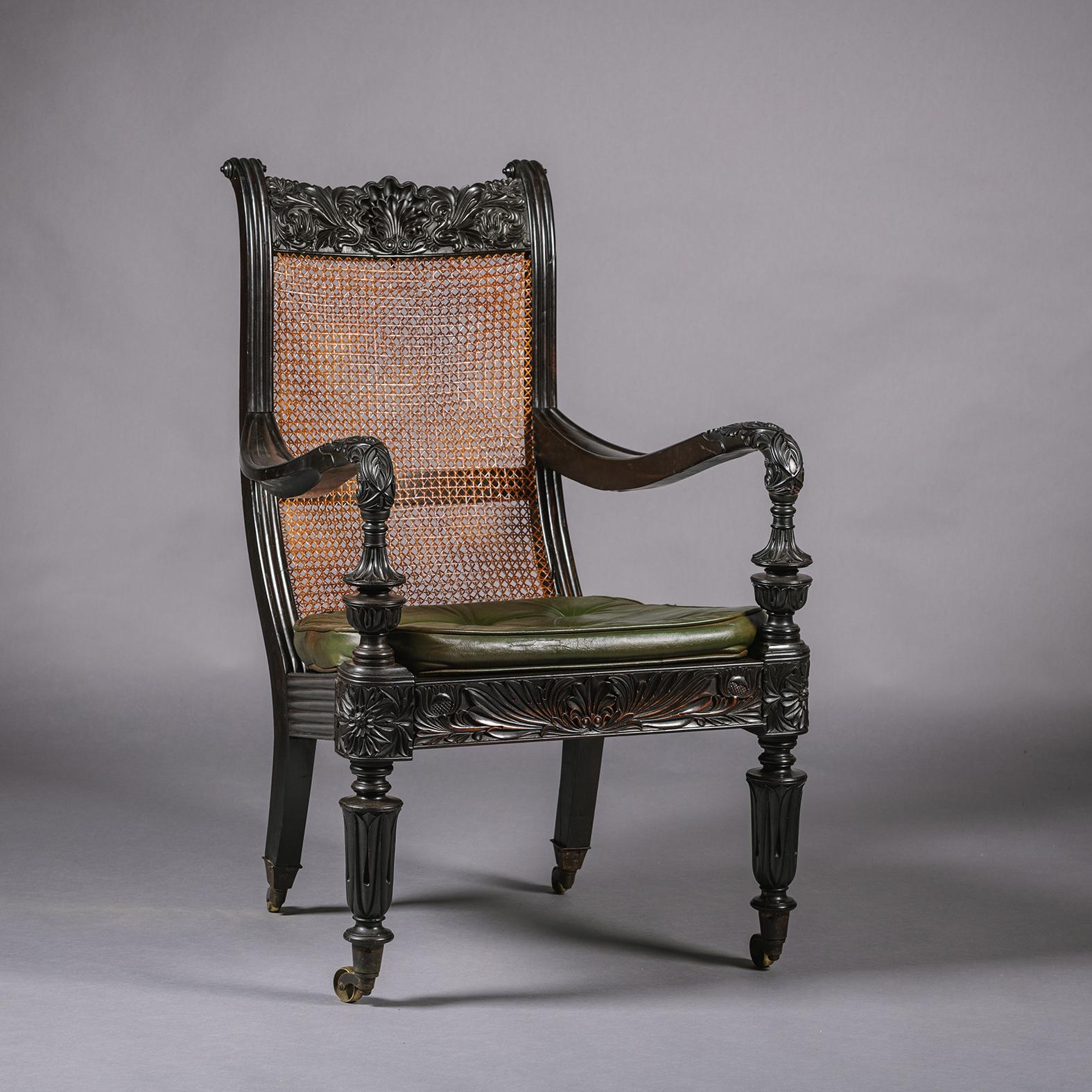 19th Century Two Anglo-Indian Carved Ebony Easy Armchairs For Sale