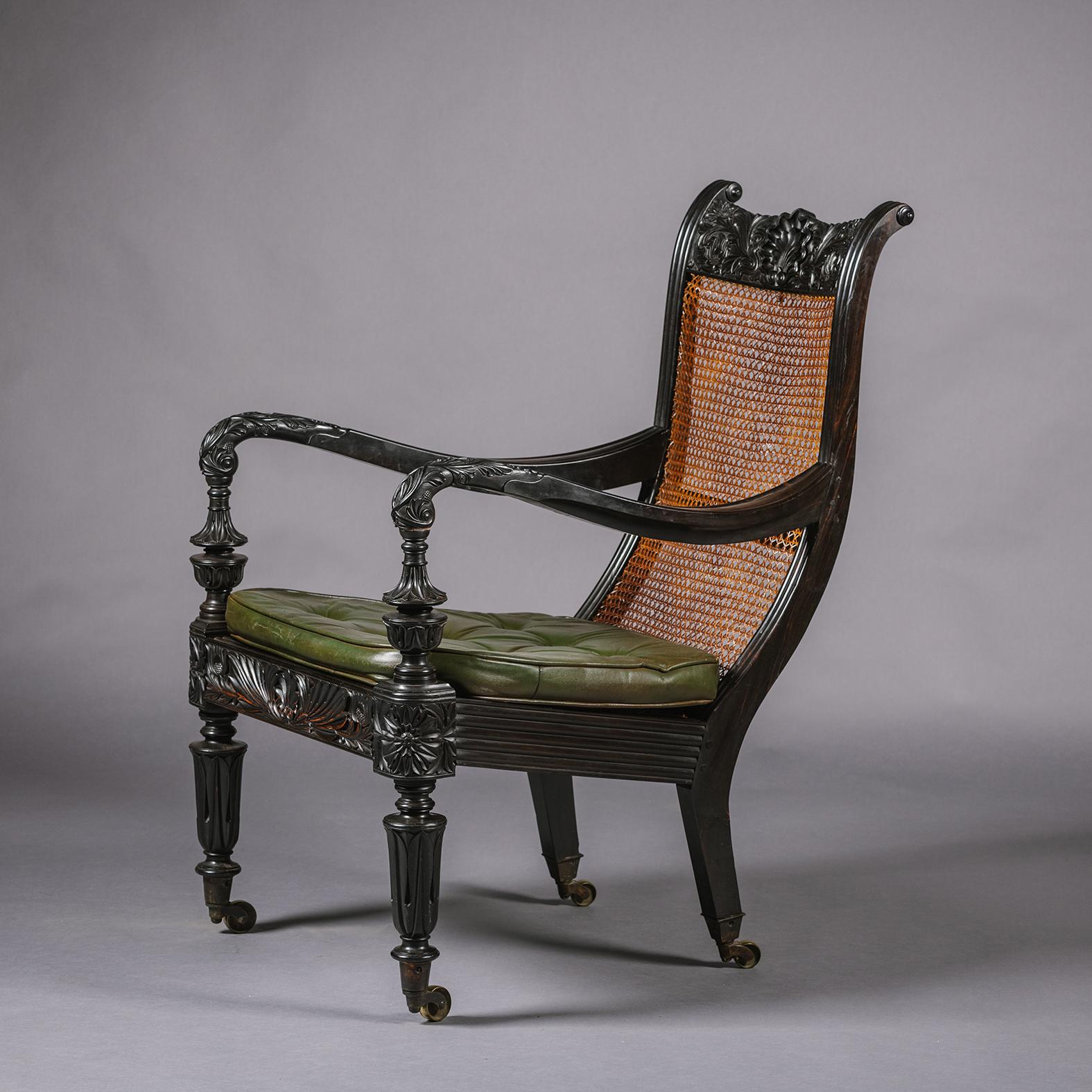 Cane Two Anglo-Indian Carved Ebony Easy Armchairs For Sale