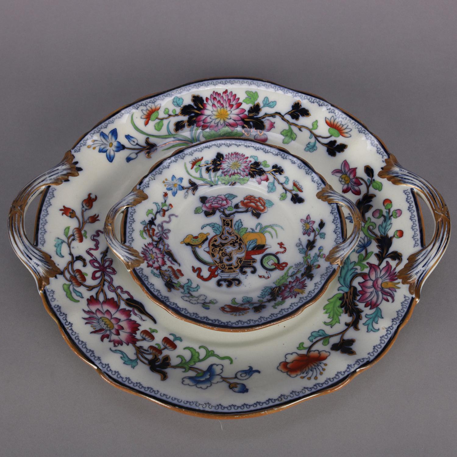Two antique English Wedgwood Noma pattern ironstone double handle platters feature polychromed, flow blue and gilt Asian floral and urn decoration, one en verso marked NOMA, mid-1800s.

Measures: 1.75