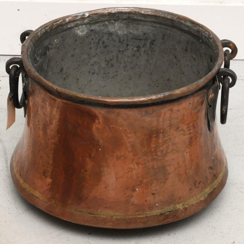 19th c., two French copper pots with snake form wrought iron handles. The brazed cramp seams around the base and up one side have been well executed. They add to the overall look of these pots as do the wrought iron handles attached with hand-made