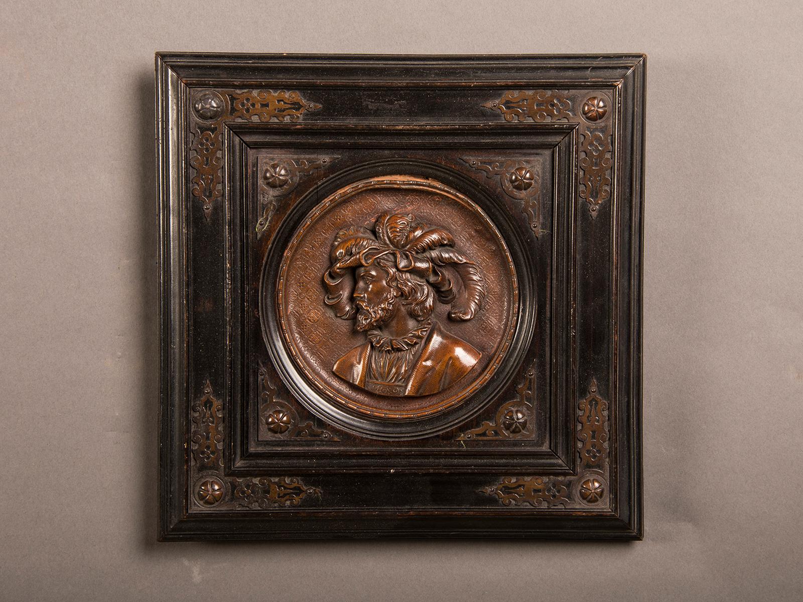 A pair of antique Italian Renaissance style cameo portraits from Italy circa 1865 featuring the bust of a lady and a gentleman rendered in bronze and inset into a square frame. Please notice that these two pieces were always meant to be seen as a
