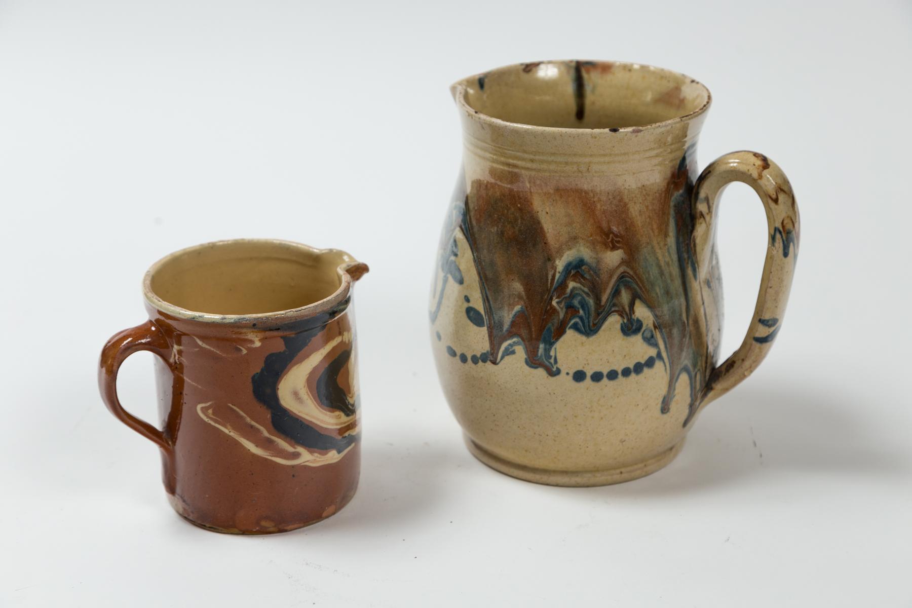 Two Antique Jaspé Pottery Pitchers, France, Late 19th Century. Striking marbleized slip application. From the Savoie region of France.