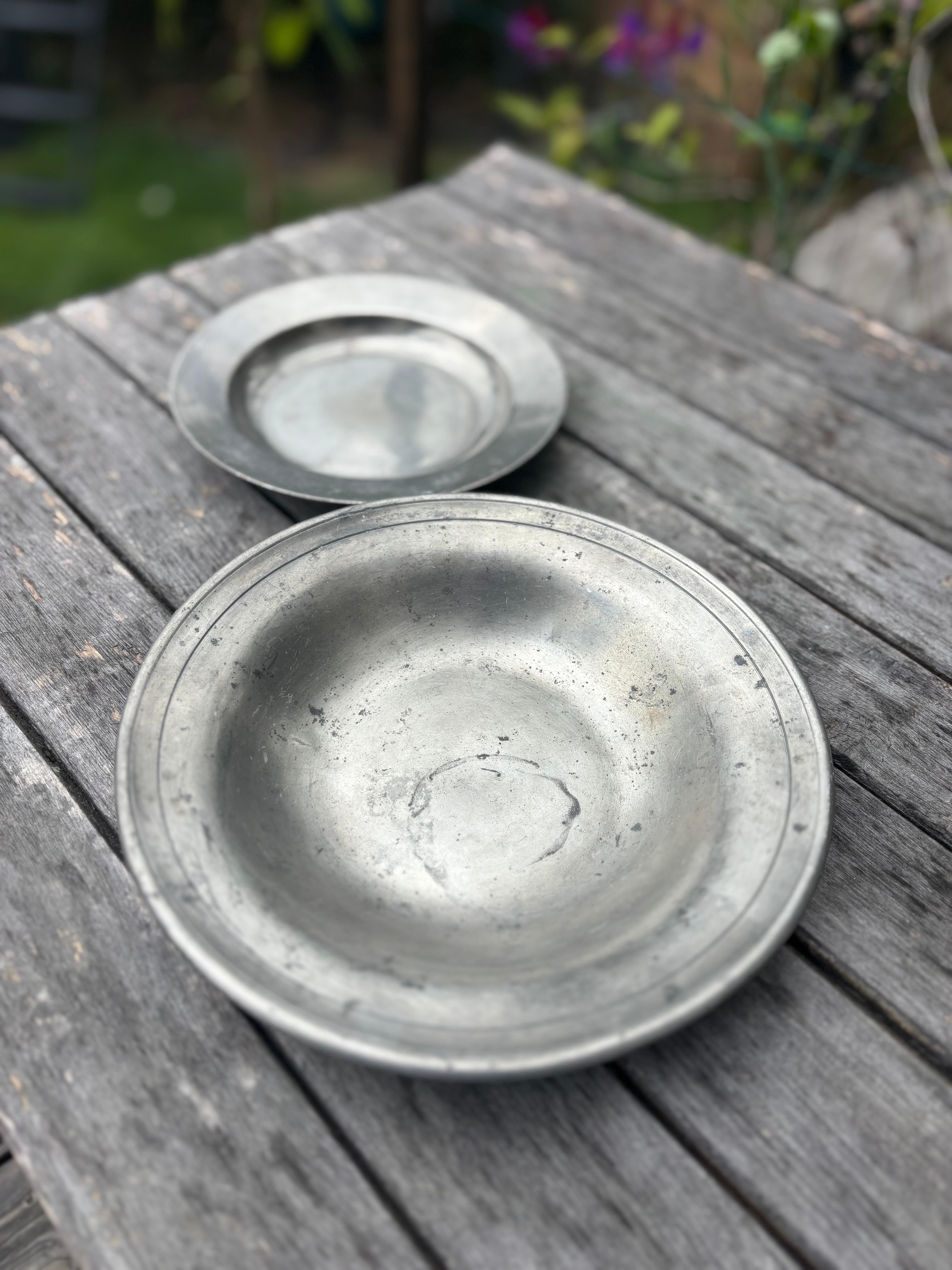 Set of two decorative rustic round pewter vide-poche bowls handmade in the 1930s. The large item is by Just Andersen, the smaller item is by a different artist. Each piece is stamped under base and in great patinated vintage condition. 
Europe,