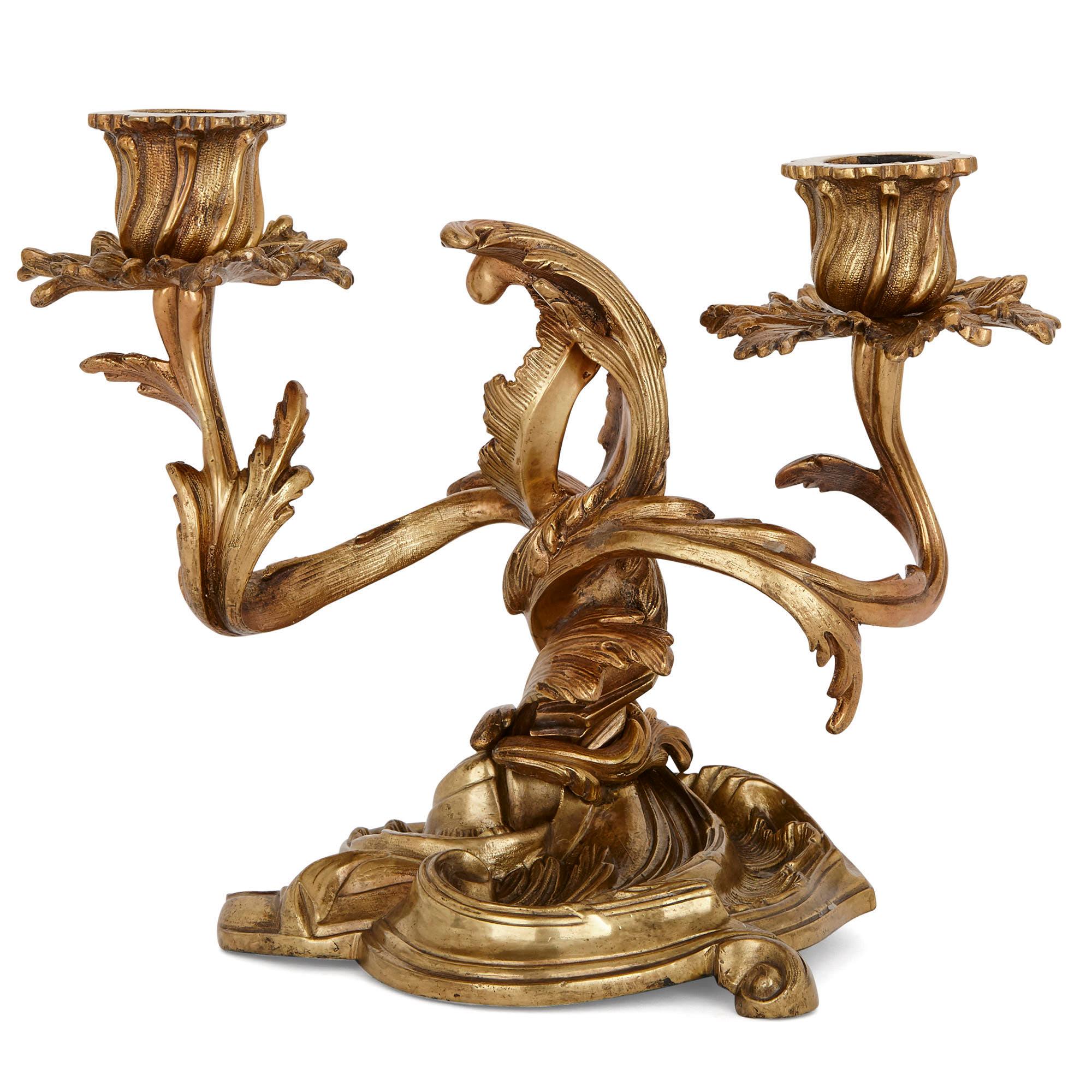 These wonderful ormolu (gilt bronze) candelabra are fashioned in the Rococo style, which first flourished in France in the Louis XV period (1715-1774). The candelabra are characteristically Rococo, being composed of elegant, organic, sinuous and