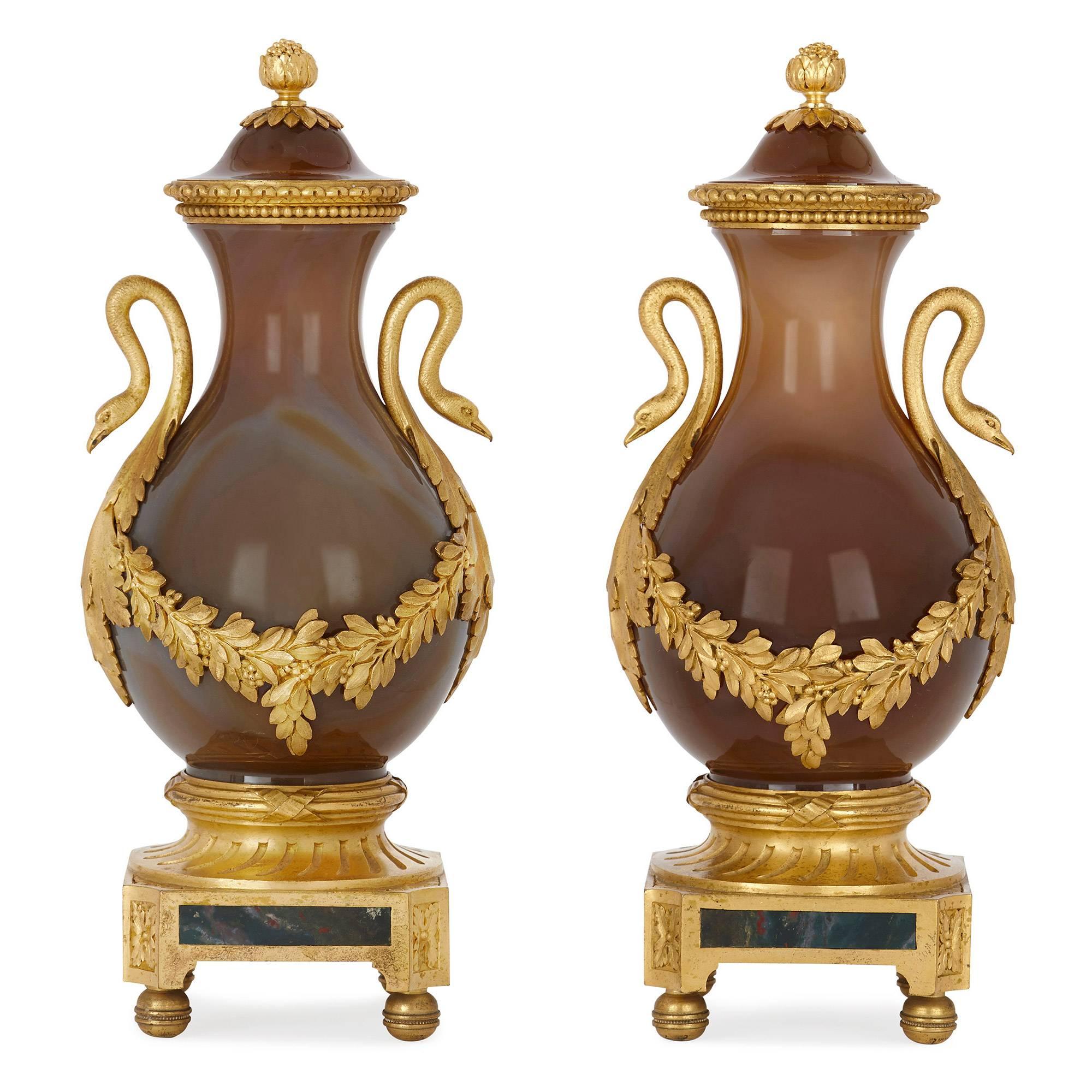 These charming agate vases are delicate in size and elegant in proportion, and were formerly in the important collection of Lord Astor of Hever, the famed English publisher of the Times. 

The vases feature curved, ovoid bodies with waisted necks