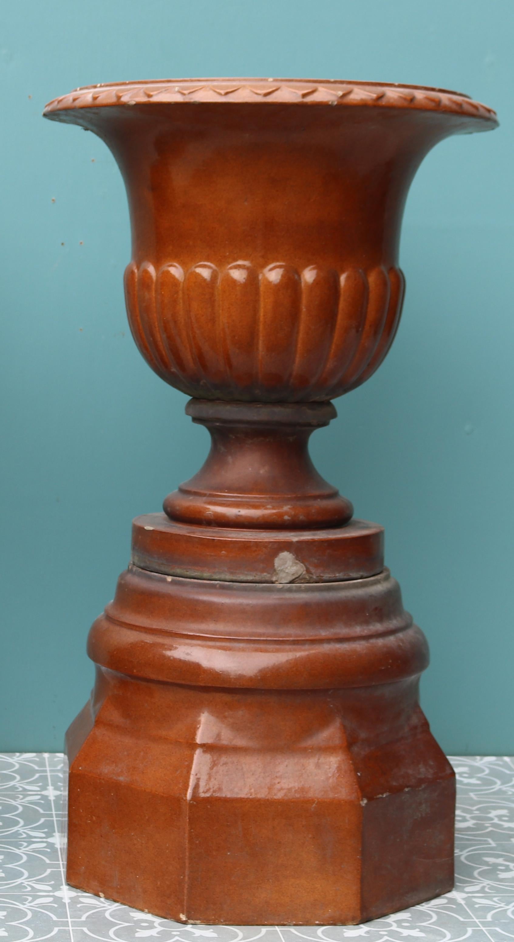 Two treacle-glazed Scottish garden urns on pedestals.

Additional Dimensions (each):

Urn Diameter 48 cm

Base 40 x 40 cm

Weight 45 kg