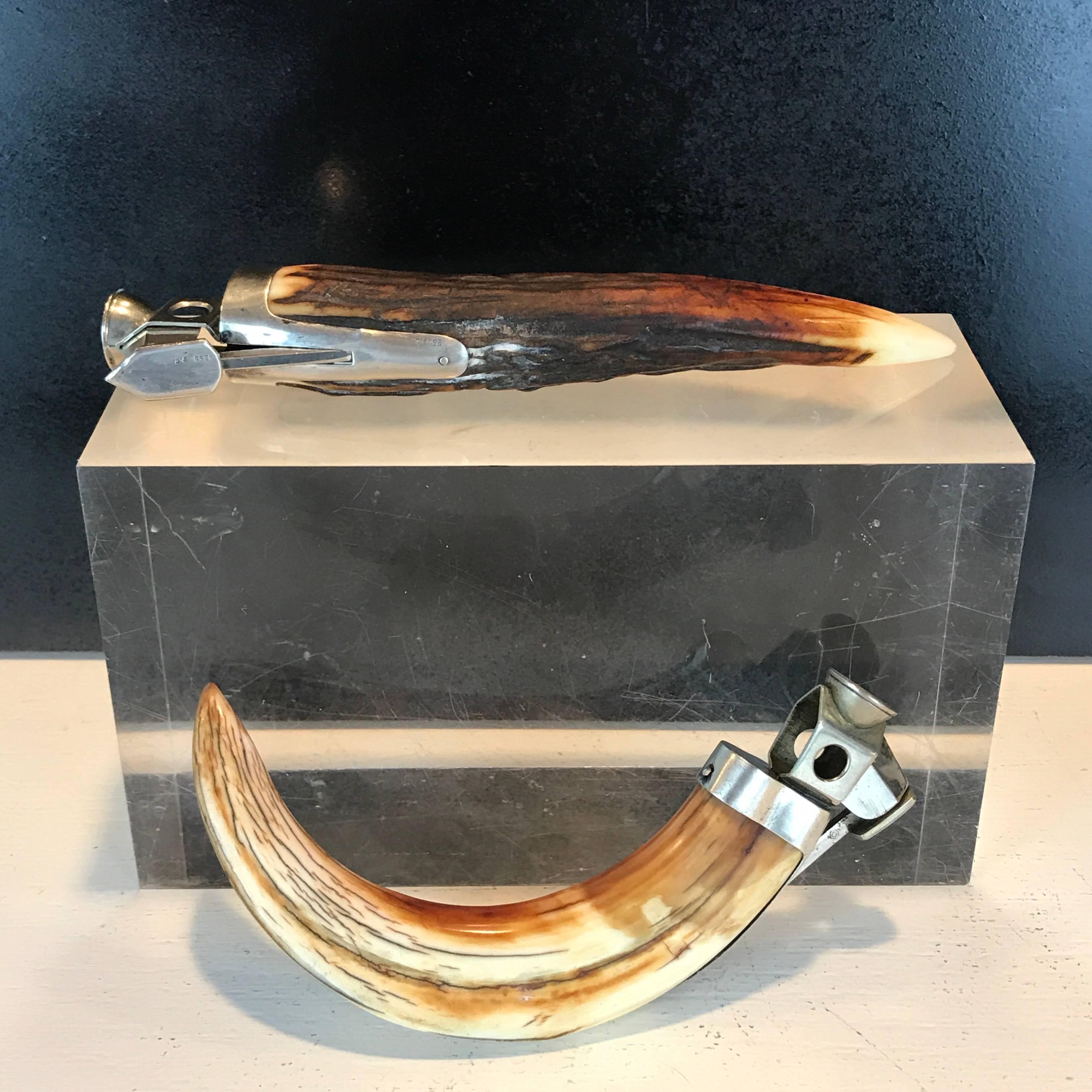 Two antique sterling mounted horn cigar cutters, each one with beautiful carved natural horn, and functioning
The curved cigar cutter measures 5.5