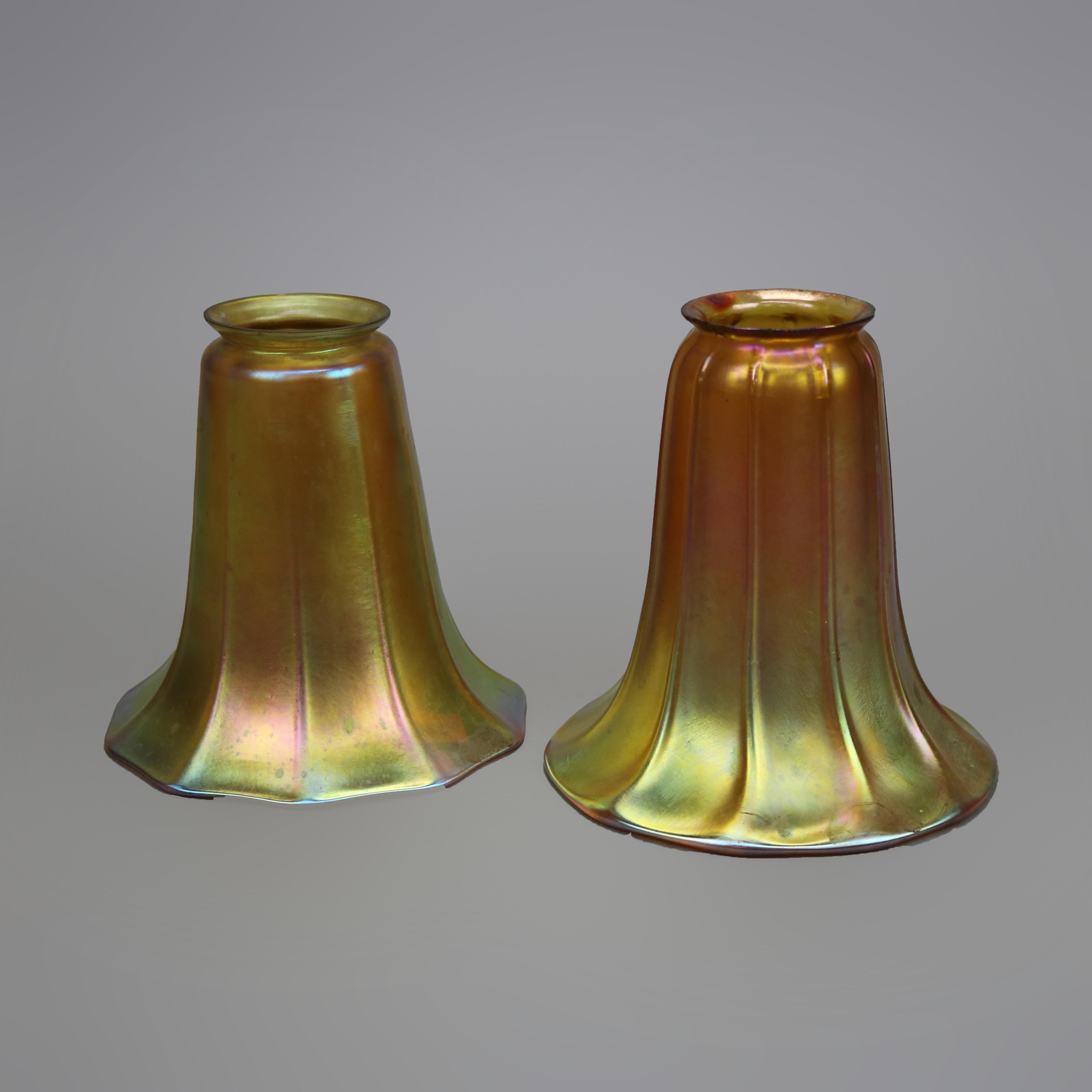 Two antique glass light or lamp shades in the manner of Steuben offer gold aurene construction in tulip form, one with acid etched maker mark as photographed, c1920

Measures - 5.75'' H X 5'' W X 5'' D; 5.5'' H X 5'' W X 5'' D.