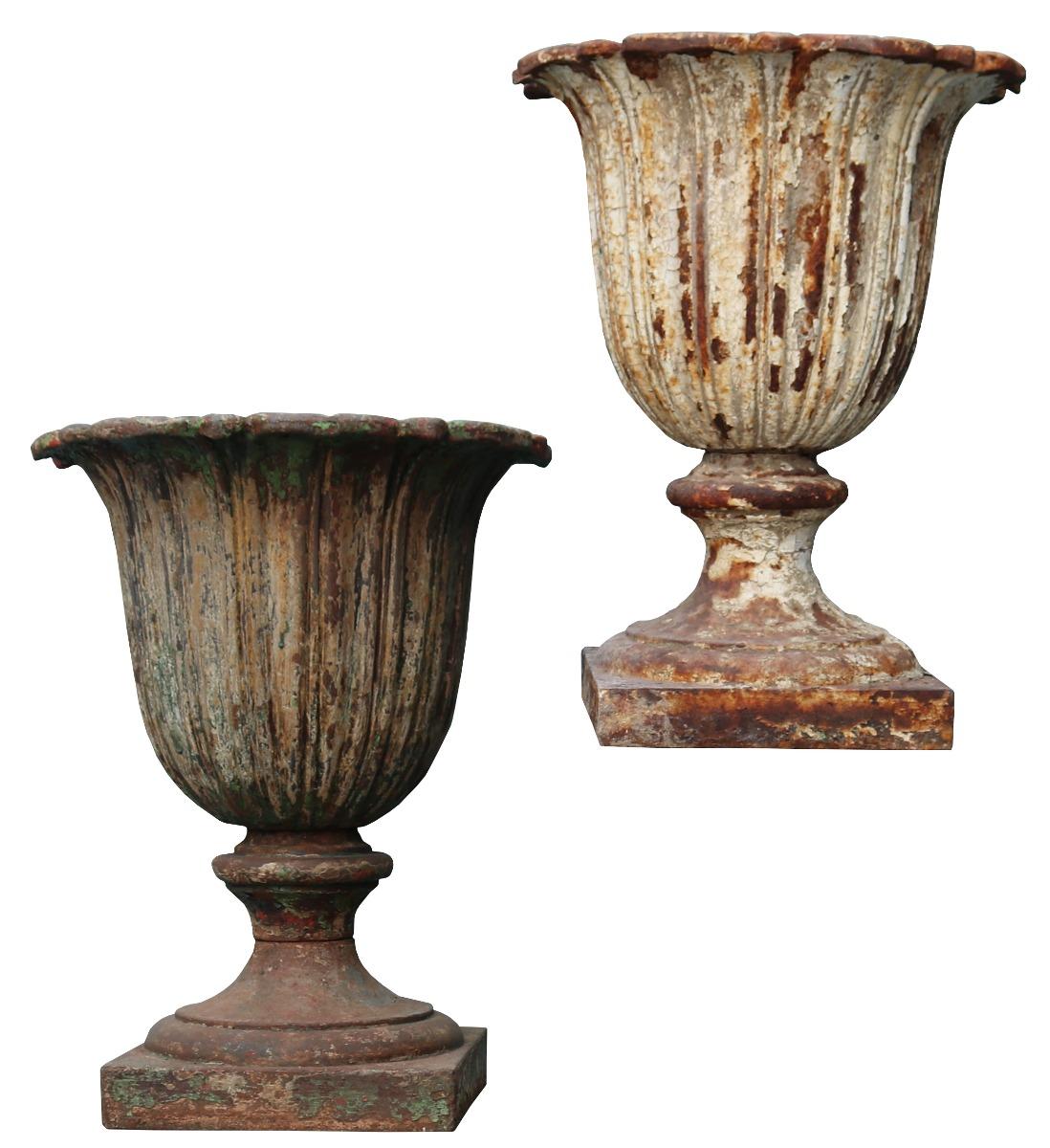 A pair of reclaimed fluted cast iron garden urns. Wooden plinths shown are not available.

Additional dimensions:

Base 28.5 x 28.5 cm.