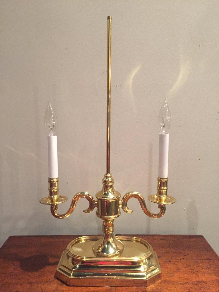 A quality brass two-arm candlestick table lamp with handsome green painted brass lamp shade, decorative finial and screw key to adjust shade height. Base is 10 x 6. Pair is available.
   