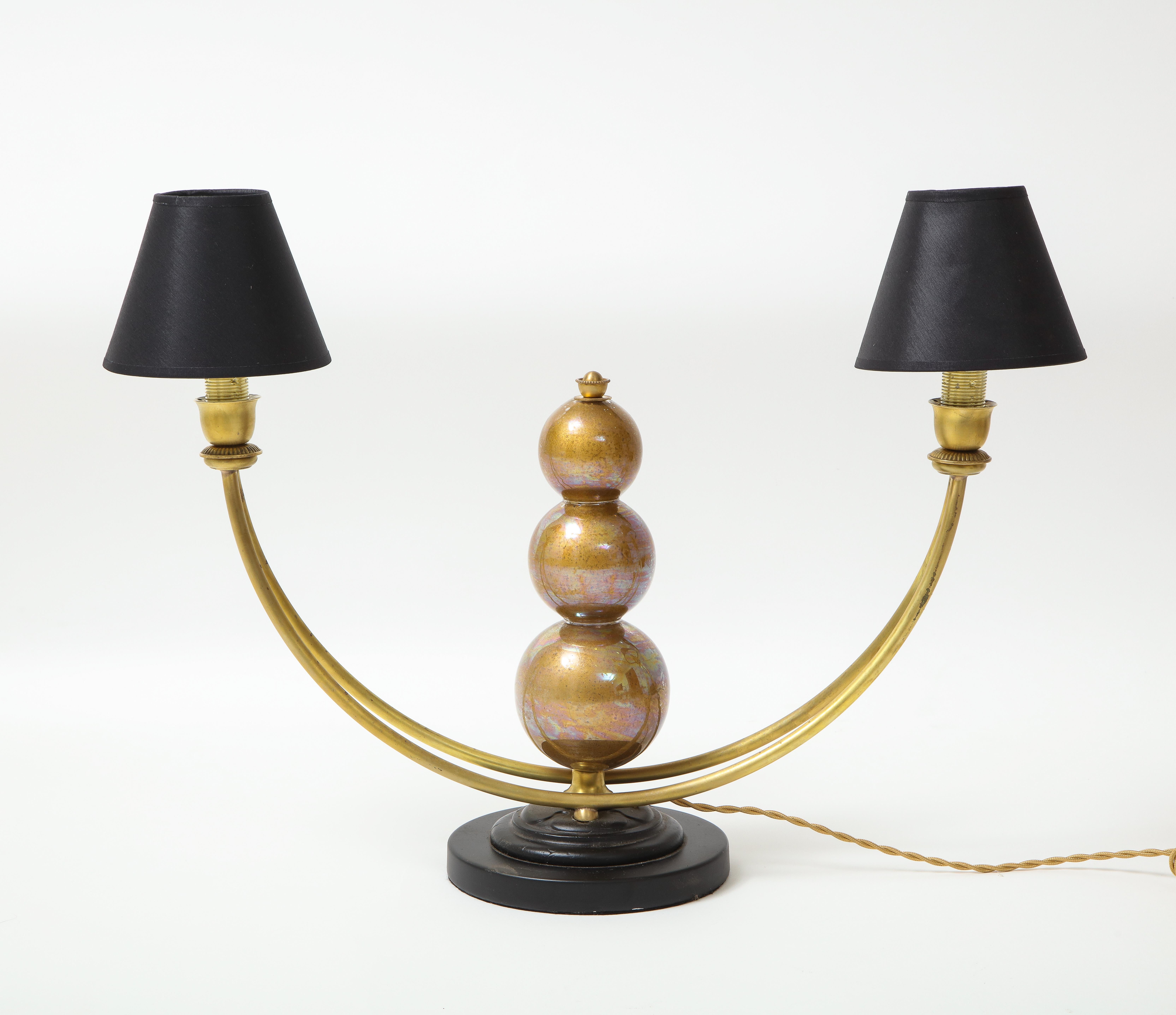 A great two arm table lamp in brass with a three Murano glass ball center stem.