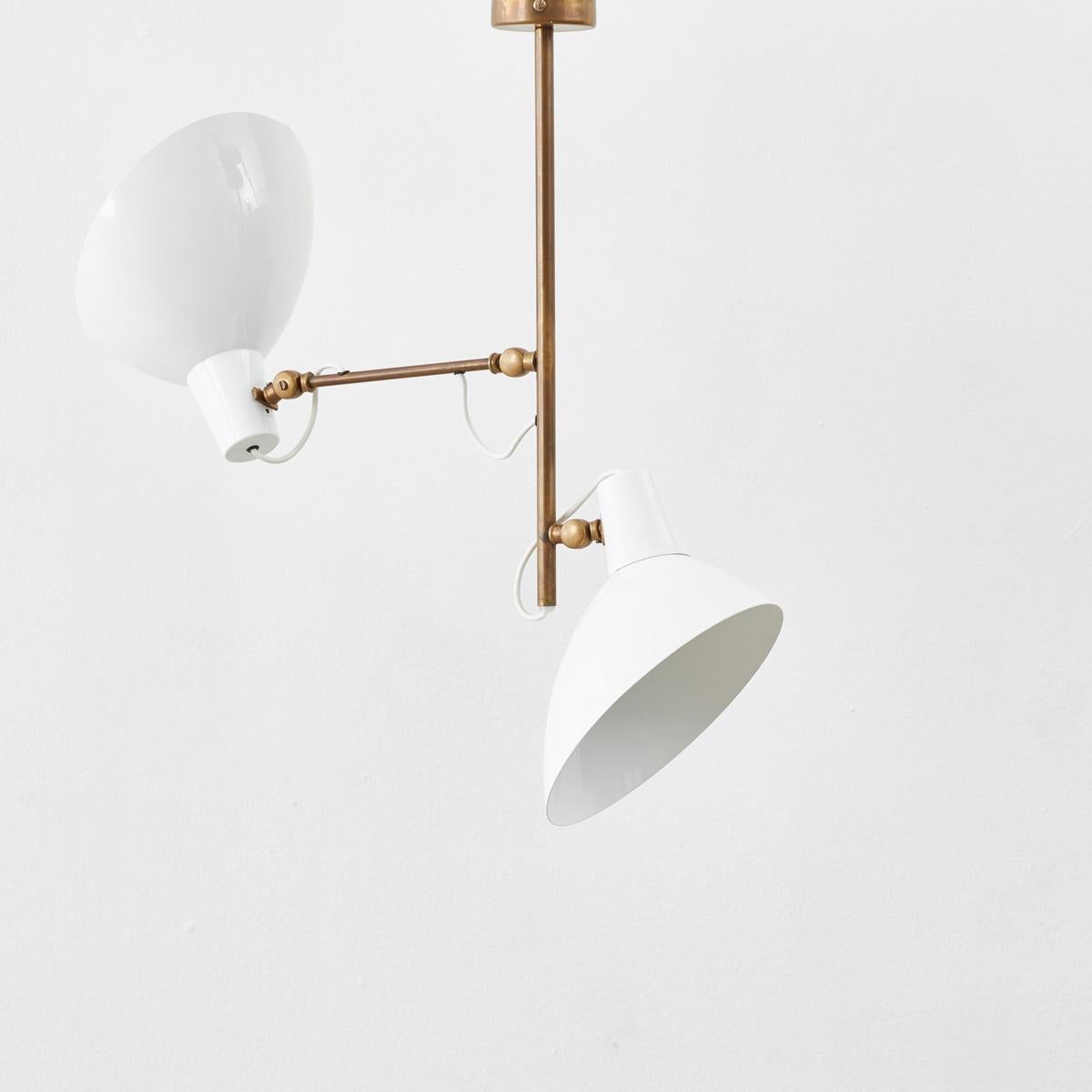 Bifurcating out from the stem of this ceiling light are two cupped shades, reminiscent of Calla lilies. Pointed in opposing directions the shades project a warm glow across any room.