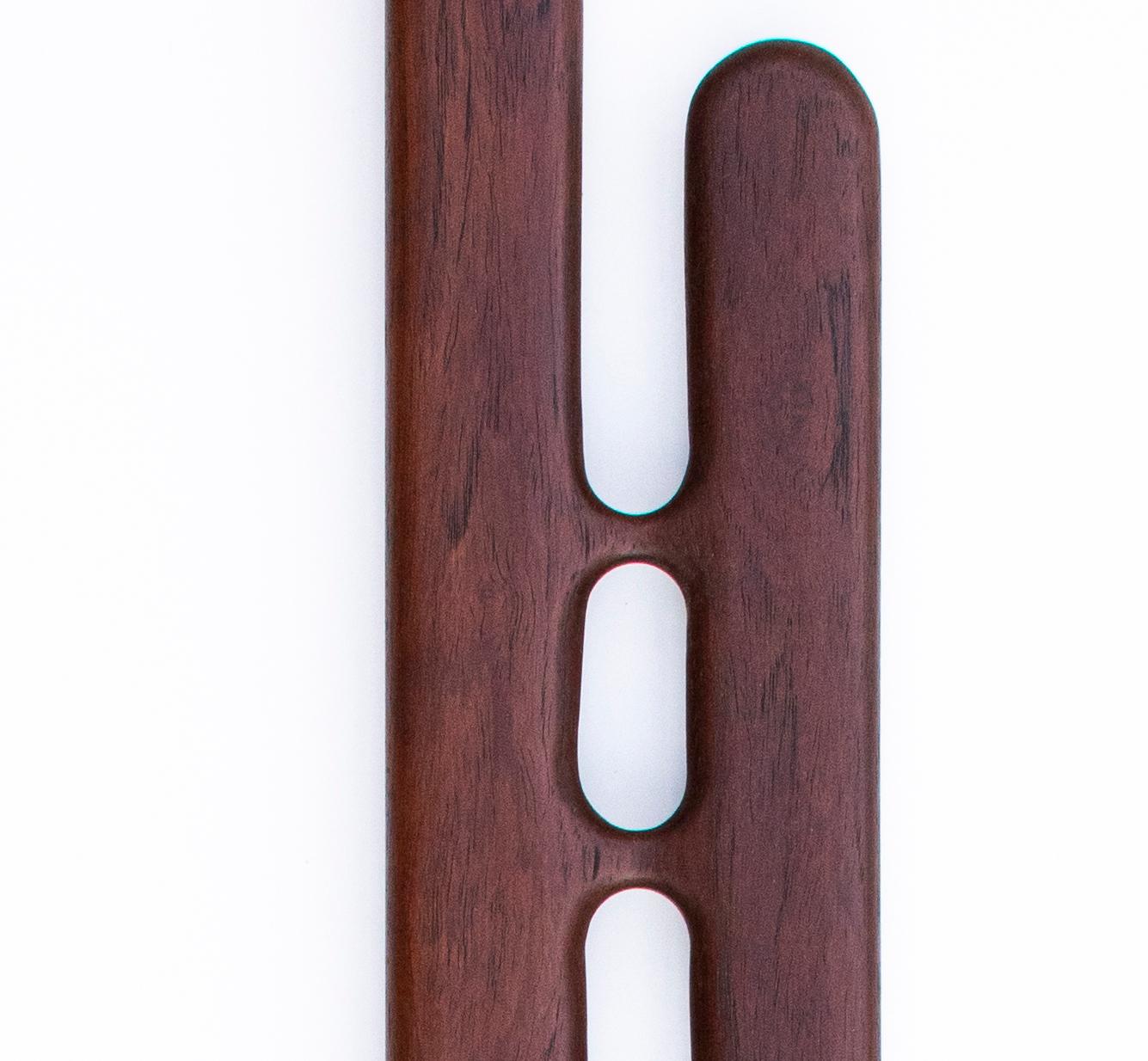 A modernist wall sculpture hand carved in Sonokeling Rosewood that embodies a captivating synthesis of form and emotion, inviting viewers into a journey of personal discovery. Its smooth surface finish, meticulously crafted, invites touch and