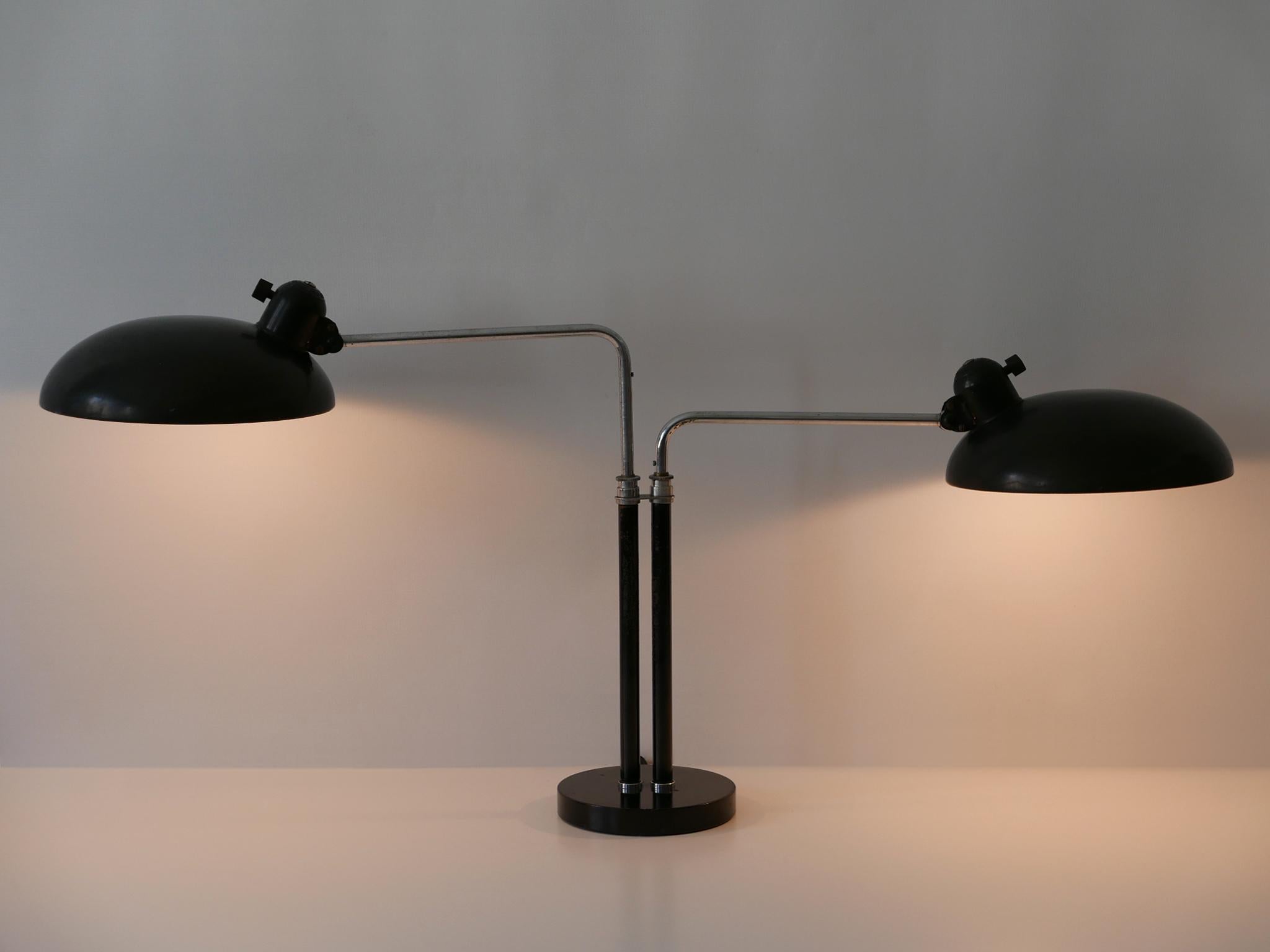 Spectacular, extra large two-armed Bauhaus / Modernist table lamp or desk light. Model 6660 Super. Adjustable and rotating arms and shades. Designed by Christian Dell for Kaiser Idell, 1930s, Germany. Makers mark on the top of the each lamp