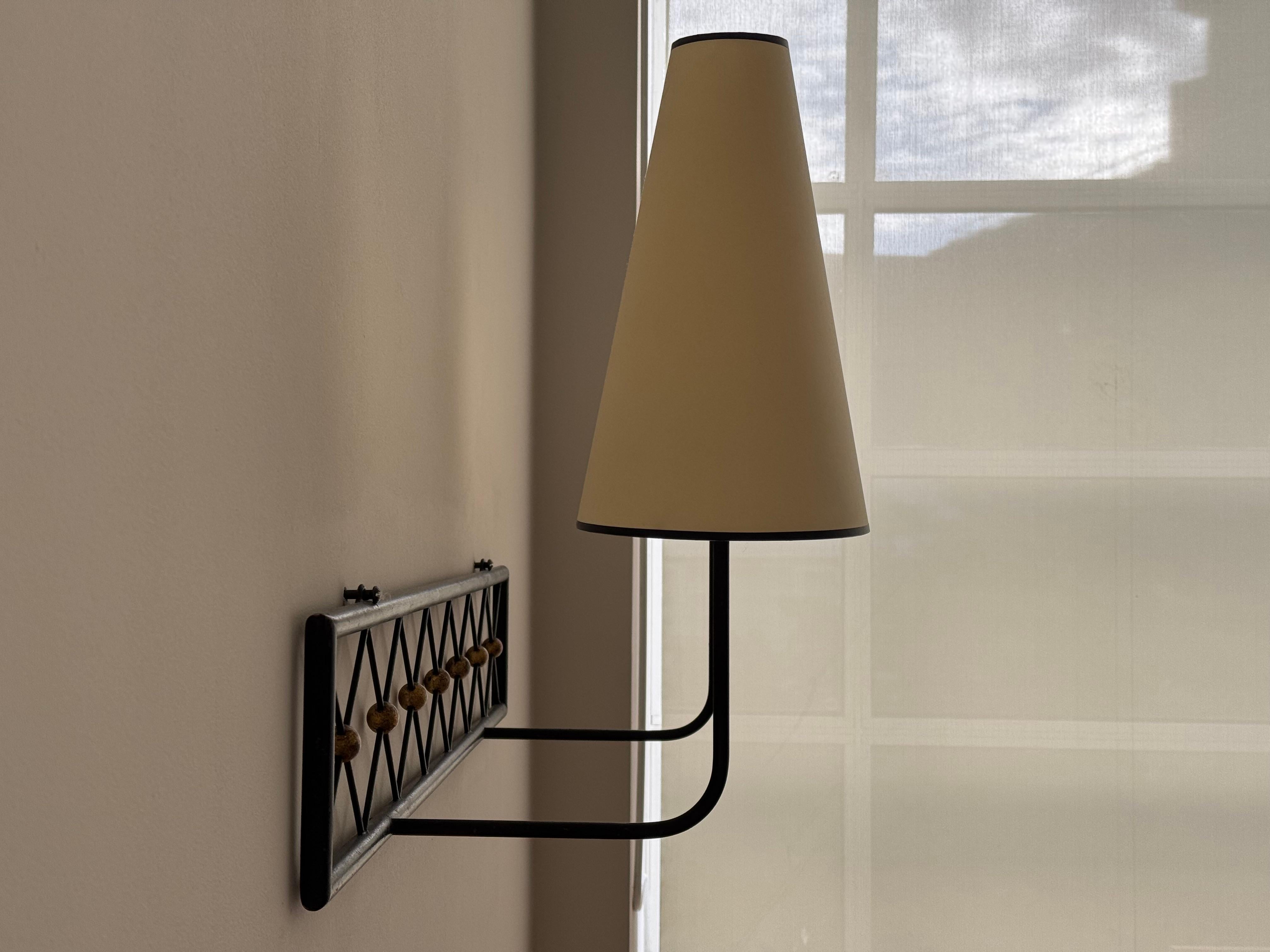 French Two-arms Tour Eiffel wall light in black painted and gilt metal For Sale