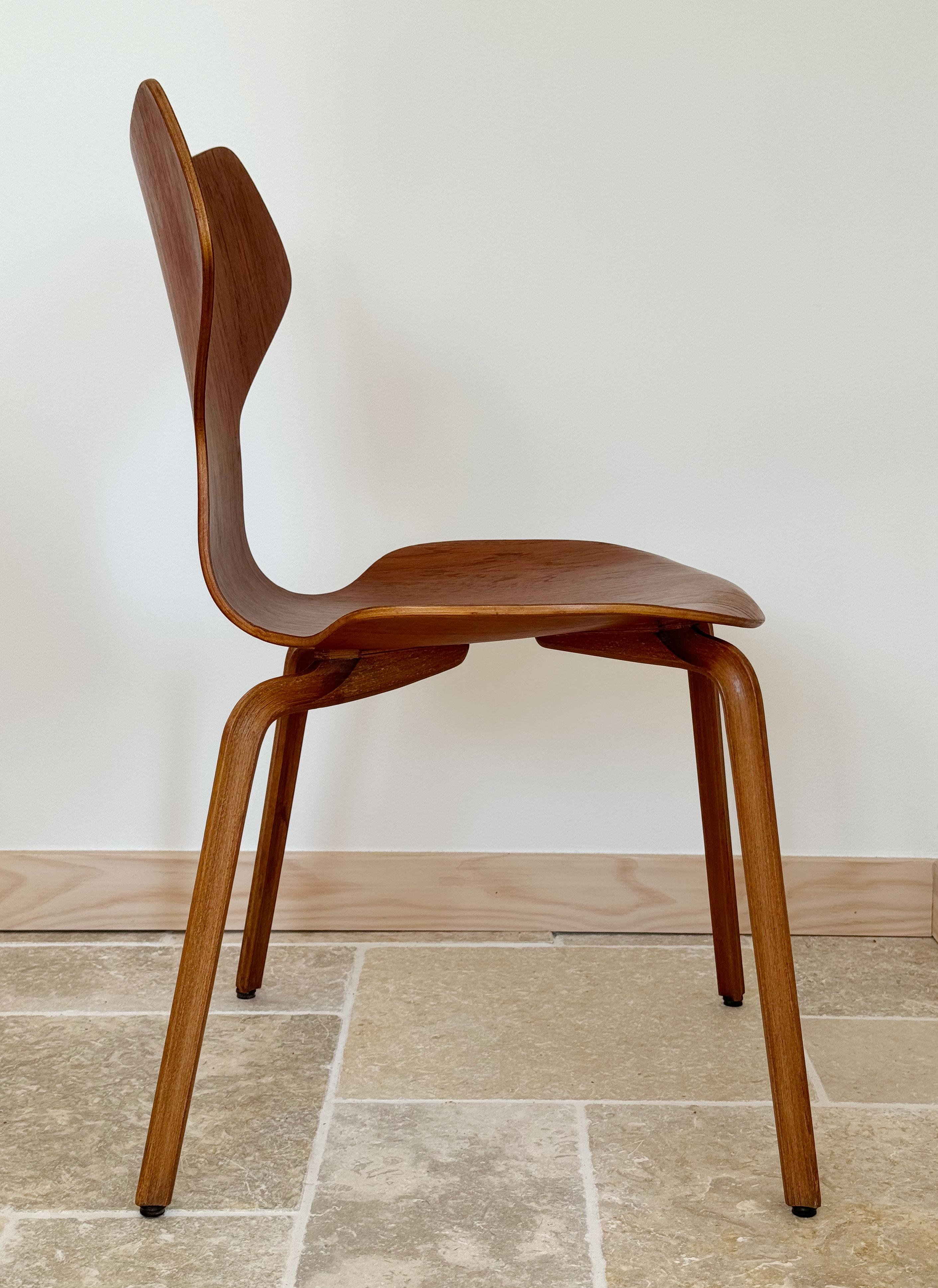 Two Grand Prix chair no. 4130 in teak, with rare provenance. 

The chair, originally known as Model 3130, was first introduced in 1957 at the Milan Triennale. It features an elegant and streamlined design, characterized by its curved wooden back and