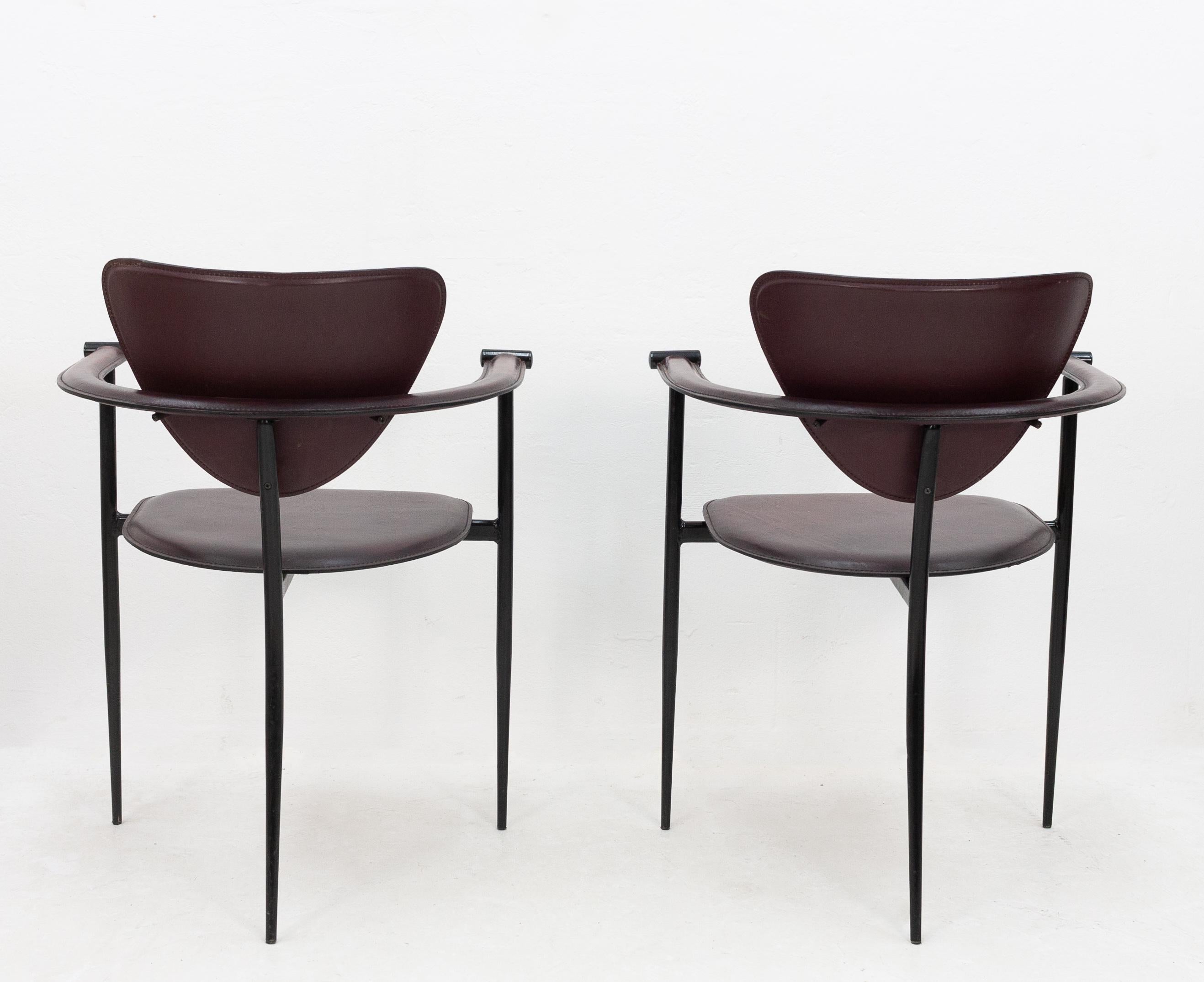 Two Arrben stiletto armchairs upholstered in black cherry leather on a black chrome frame. Italy 1970s. The bottoms of the seats have had some repair work done where the leather had split apart, see photos.