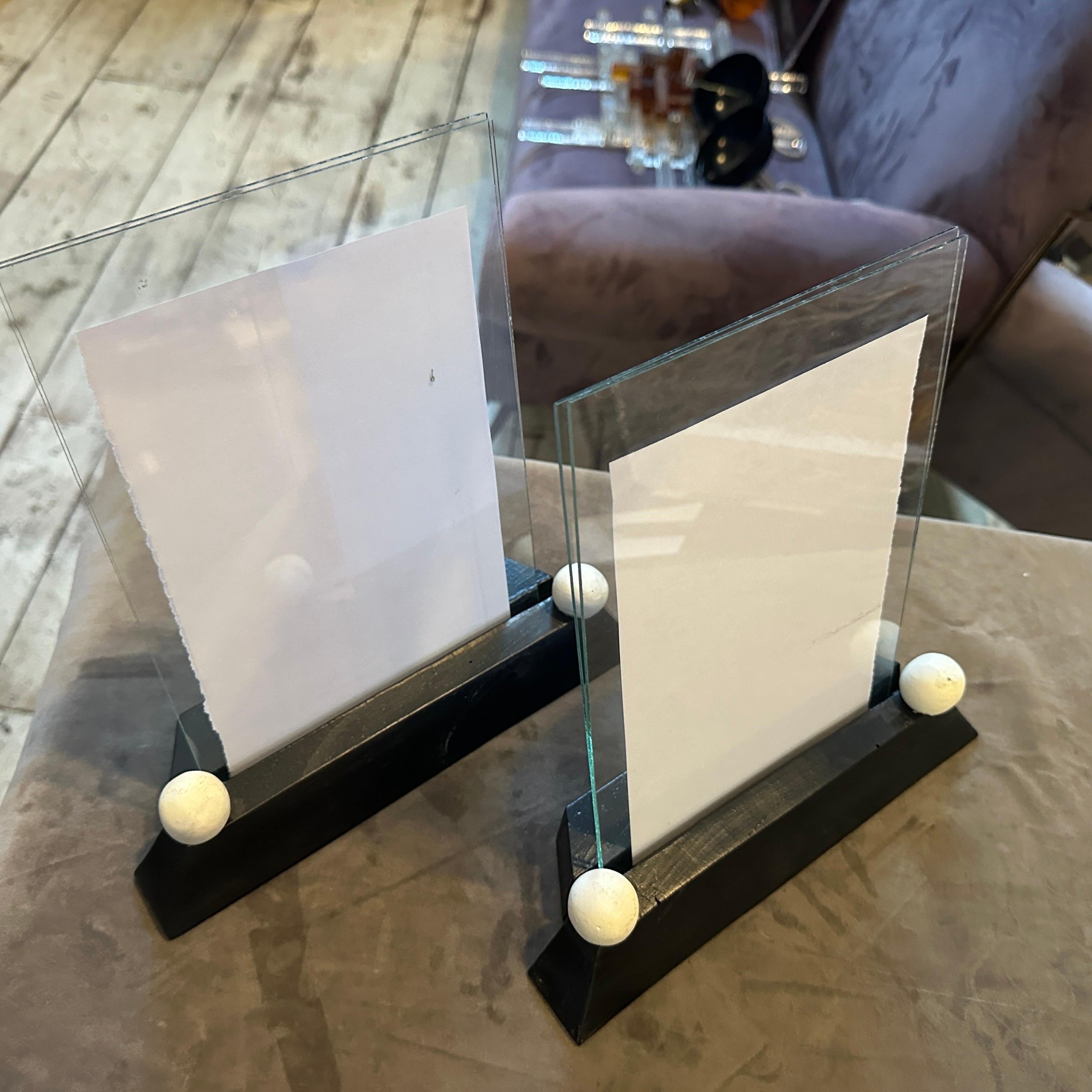 It's a striking pair of Art Deco Black and White Lacquered Wood French Picture Frames, epitomizing the elegance and geometric sophistication of the 1920s and 30s. These exquisite frames are designed to showcase your cherished photographs with a