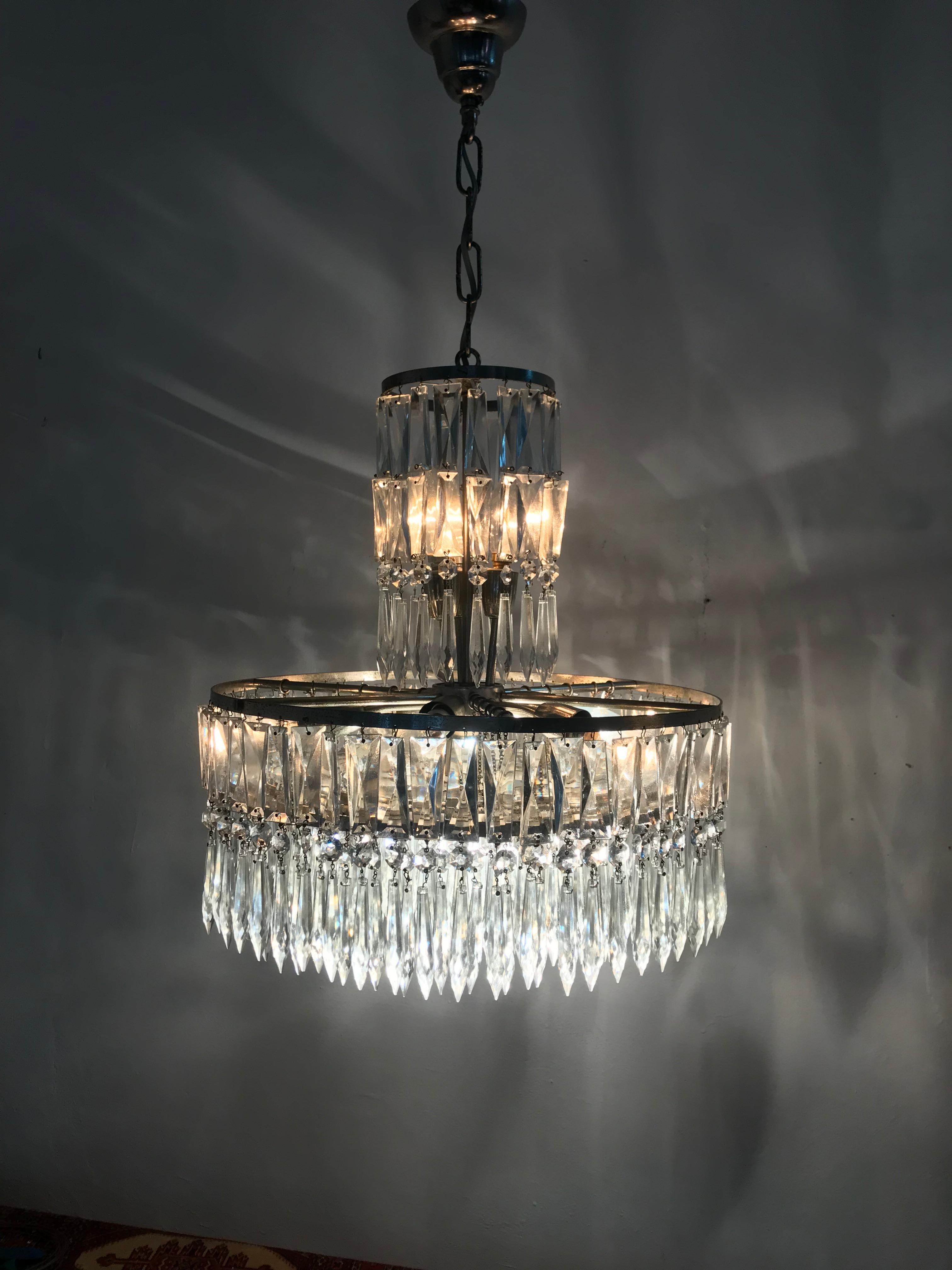 Identical pair of 10 light French Art Deco chandeliers, in nickeled steel and a few hundred cut lead crystal prisms. Made in France, circa 1940.
Priced individually.