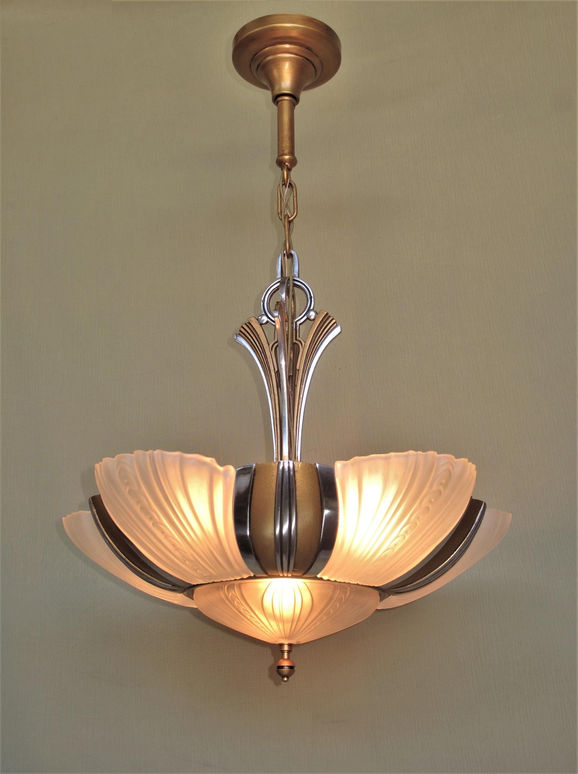 Two matching 7 light bulb 1930s Art Deco ceiling fixtures, priced each.
Restored to original colors including highly polished aluminum accents (NOT painted) and a warm antique golden body color. There two sockets lighting the bottom shade along with