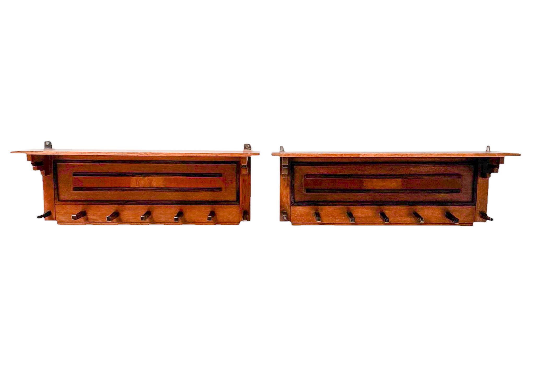 Stunning and rare pair of Art Deco Modernist coat racks.
Design by P.E.L. Izeren for De Genneper Molen.
Striking Dutch design from the 1920s.
Solid oak and original oak veneered frames with original walnut and macassar ebony veneered elements.
Each