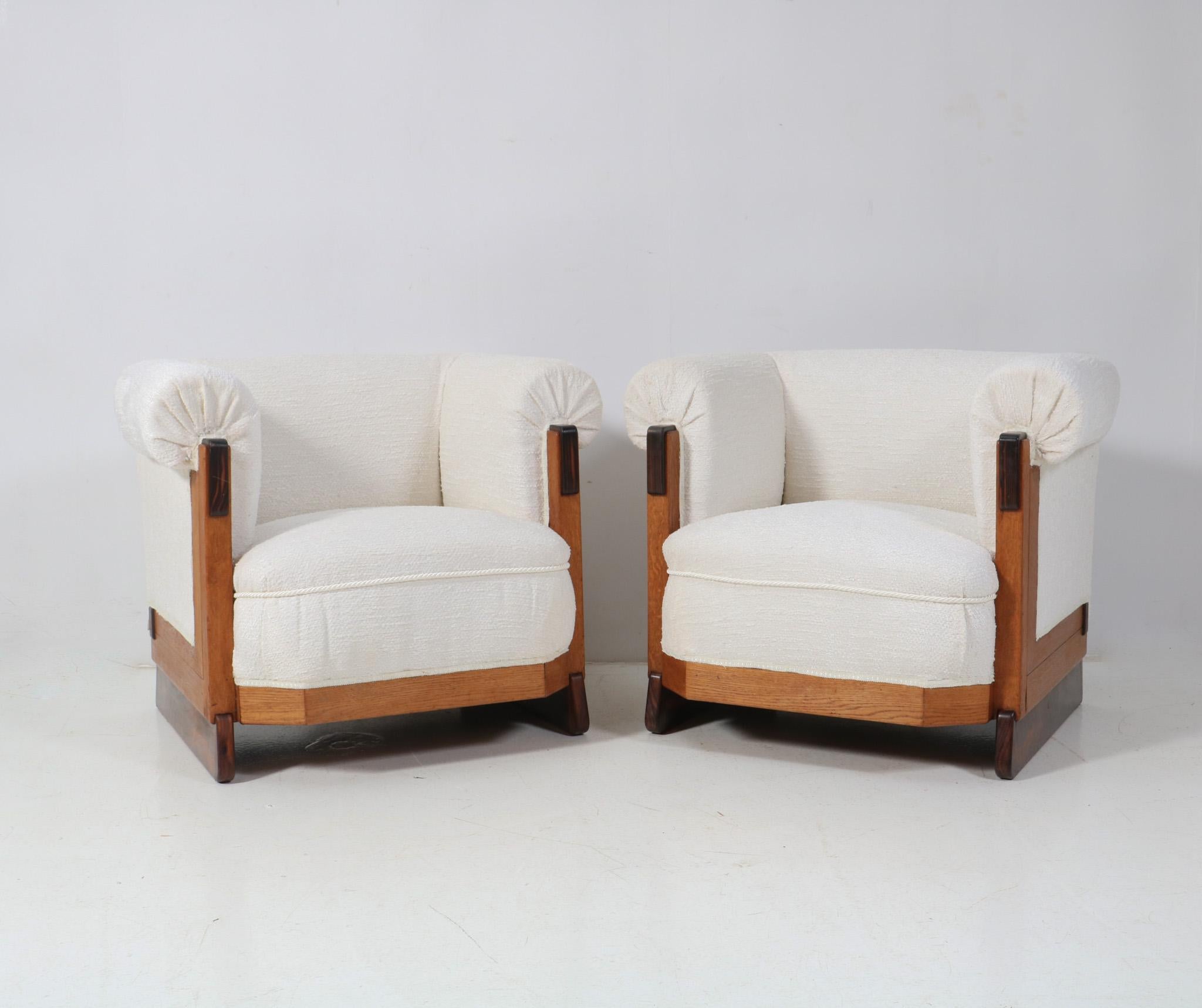 Magnificent and ultra rare pair of Art Deco Modernist lounge chairs.
Design by Anton Lucas for N.V. Meubelkunst Leiden.
Striking Dutch design from the 1920s.
Solid oak frames with original solid macassar elements.
Re-upholstered with an off-white