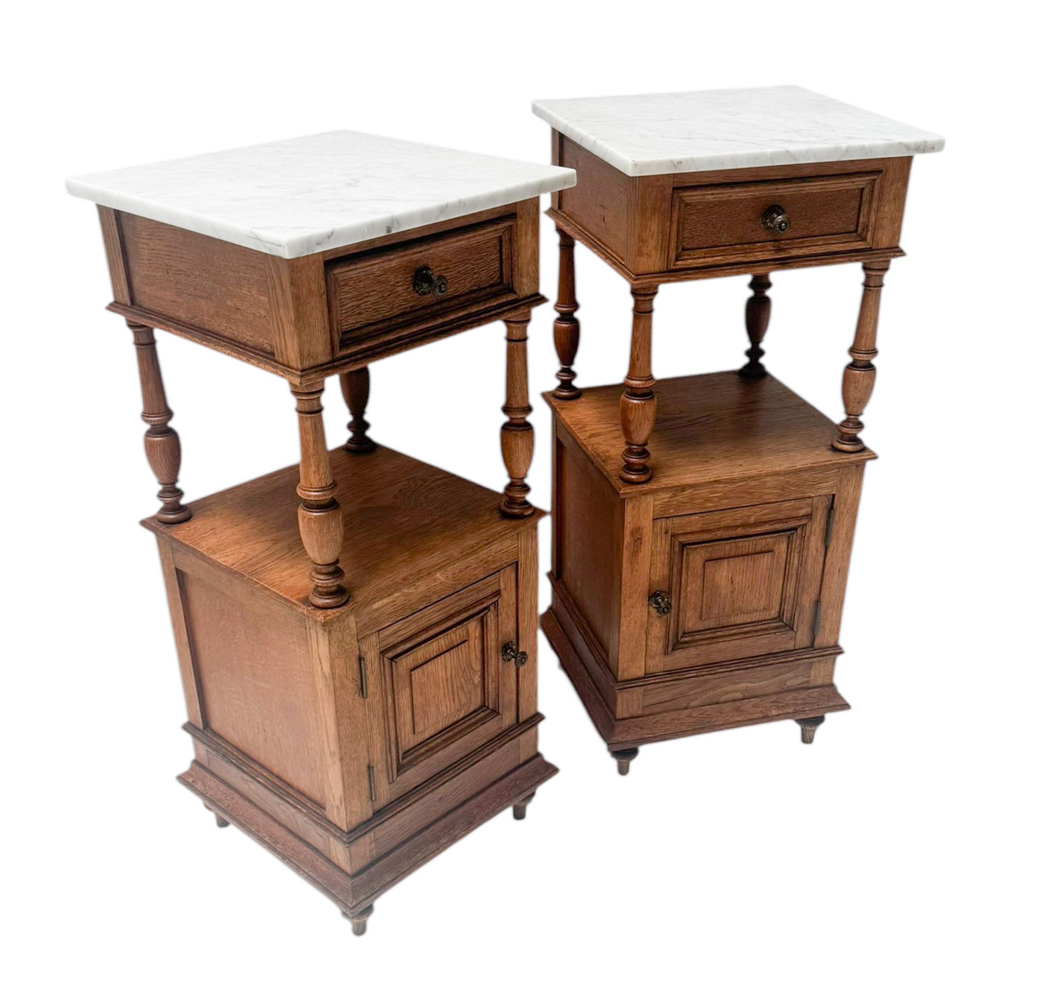 Stunning and elegant pair of Art Nouveau nightstands or bedside tables.
Striking Dutch design from the 1900s.
Solid oak bases with original patinated brass knobs on drawers and doors.
Original white marble tops.
This wonderful pair of Art Nouveau