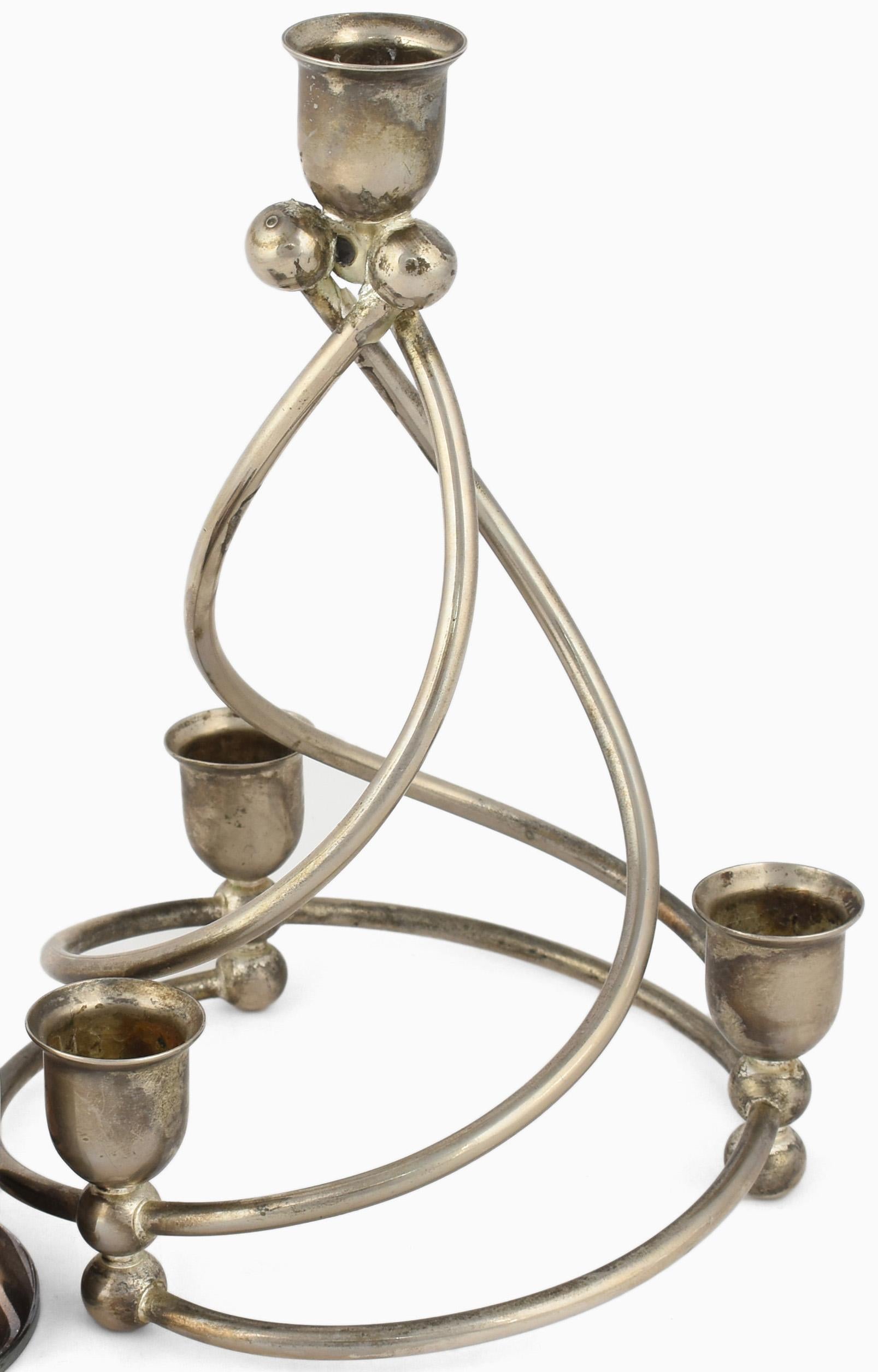 Two spiral candlesticks is an original decorative pair of objects realized in the 1920s. 

Original silver plated metal. The pair includes: one silver plated candlestick (H. 8 cm) and one metal silver-colored candlestick (H. 22.5 cm). 

Made in