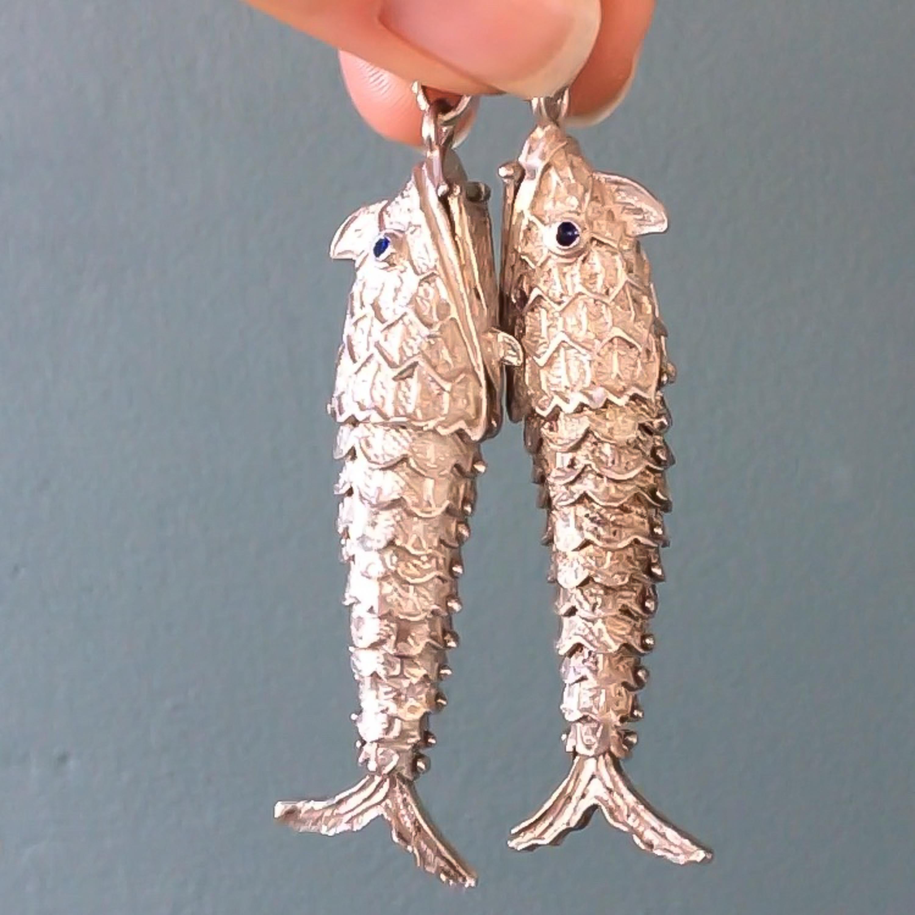 These two vintage articulated silver fish pendants are gorgeous. The fish are moving and wiggle their tails and body. The fish consist of multiple sections, which inside are held together by pins that allow the fish to move back and forth. The