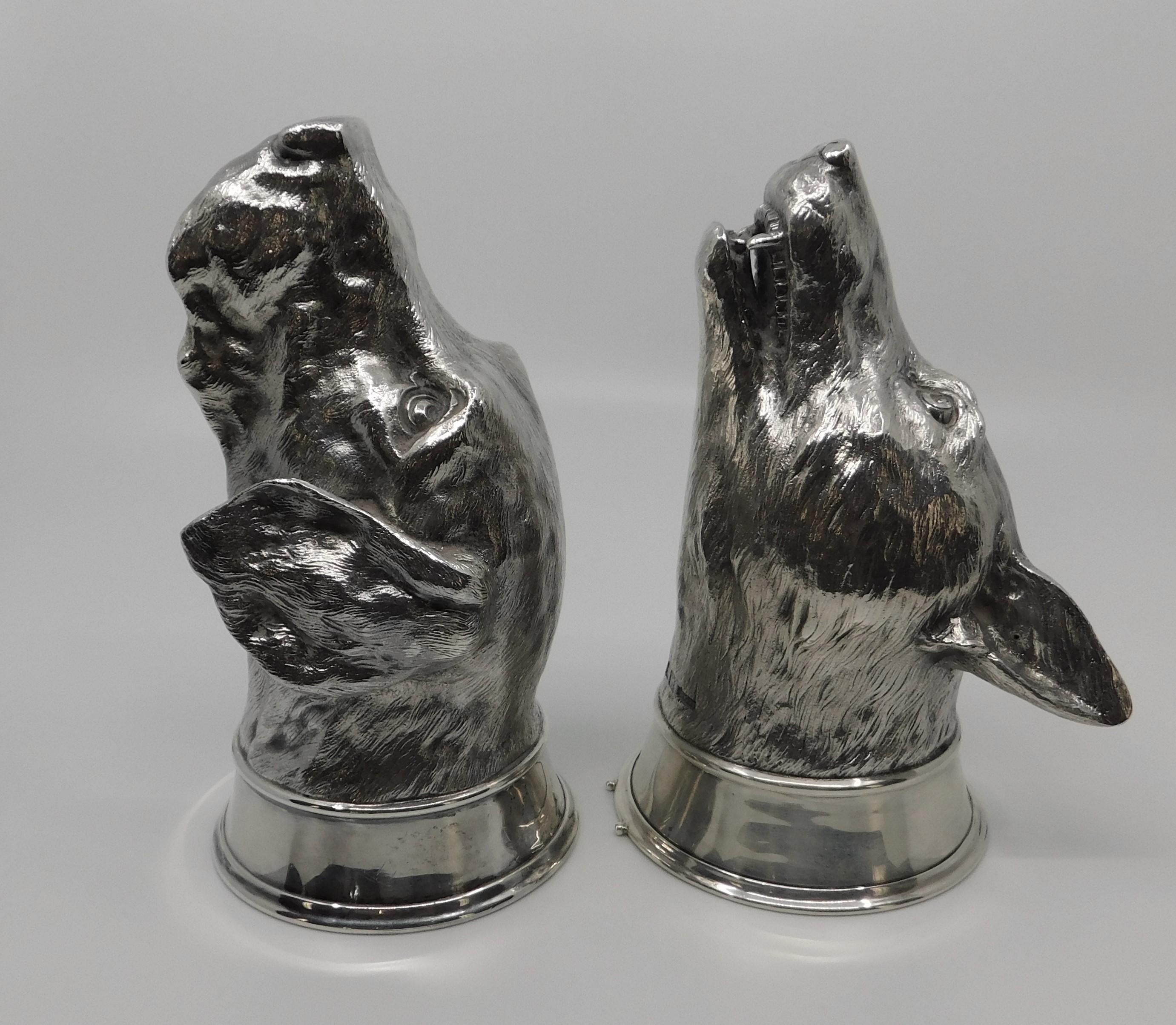 Pair of Asprey & Co., London sterling silver stirrup cups each fully marked on neck. The first in the form of a hound dog dated 1958, measuring 6.75 inches long x 3.5 inches round. The second is an open-mouthed fox dated 1959 measuring 6.5 inches