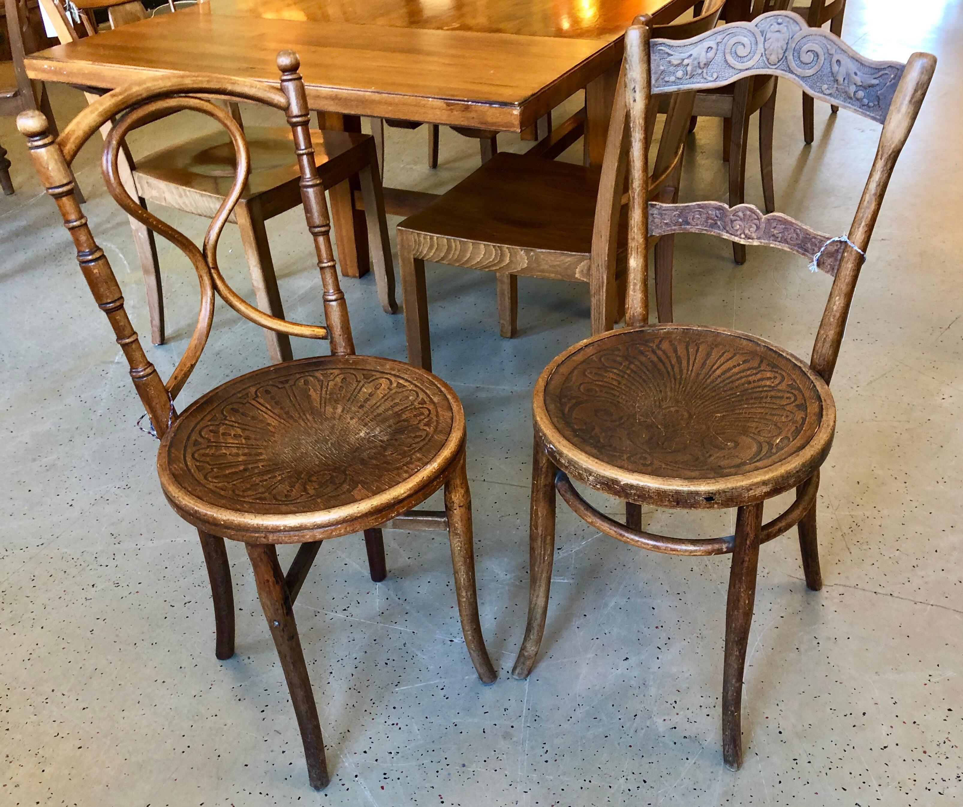 Pair of depression era authentic bistro carved wood chairs.
