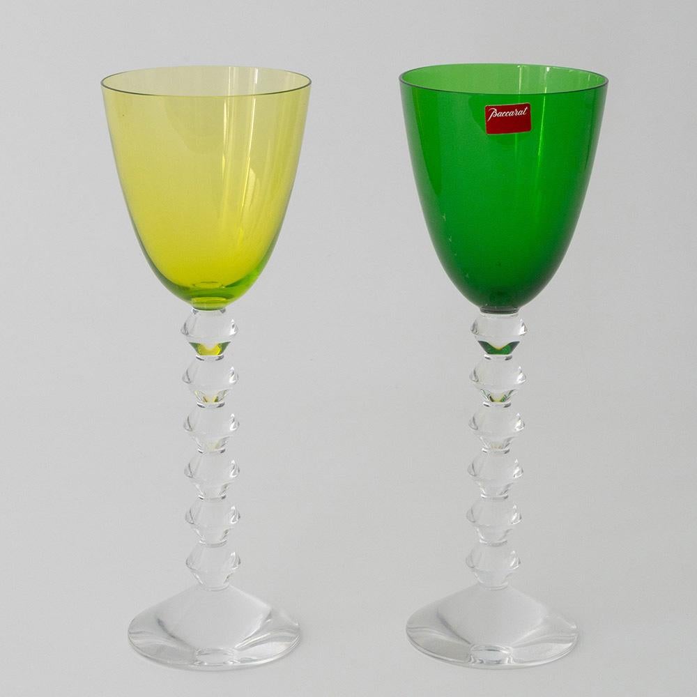 Heading :  Pair of Baccarat Vega wine glasses with emerald and pale green bowls
Period : Modern
Origin : Baccarat, France
Colour : One pale green one emerald green bowl, clear stems
Bowl : Round funnel
Stem : Formed of angular knops not dissimilar