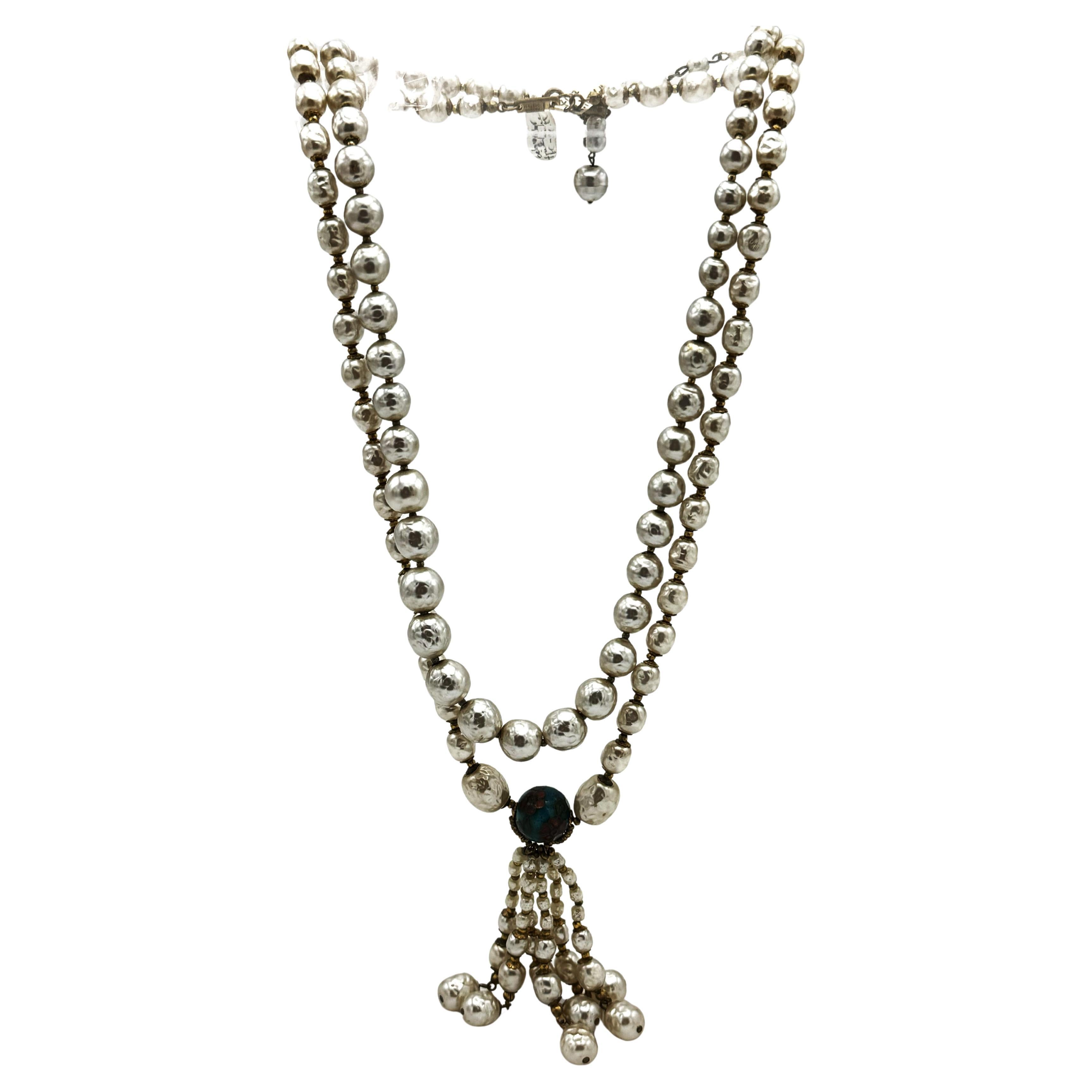 Two single strands of faux silver baroque pearls necklace , on with a tassel with 6 filligree-cappet baroque pearls, 6 cm long. The other M. H. necklace with larger silver broque pearls, pearl size 1 cm diameter to 0.6 cm . Between the