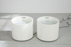 Two barrel-shaped illuminated tables made of white lacquered wood, Italy 70s