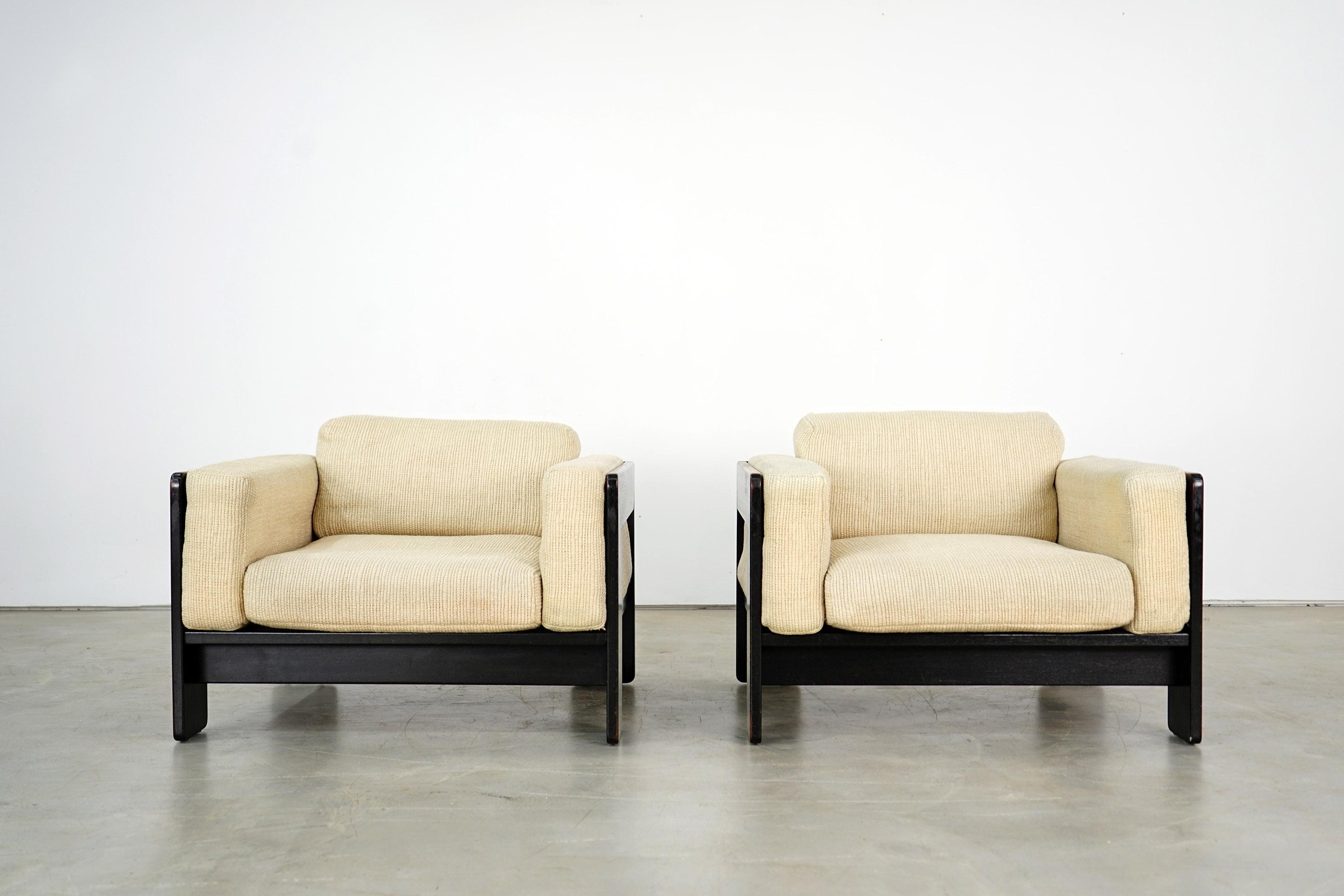 This set consists of two armchairs from the Bastiano series by Afra and Tobia Scarpa. The armchairs have black ebonized oak frames and original sand-colored pillowcases. The upholstery of the pieces has been renewed. Accordingly, they are in an