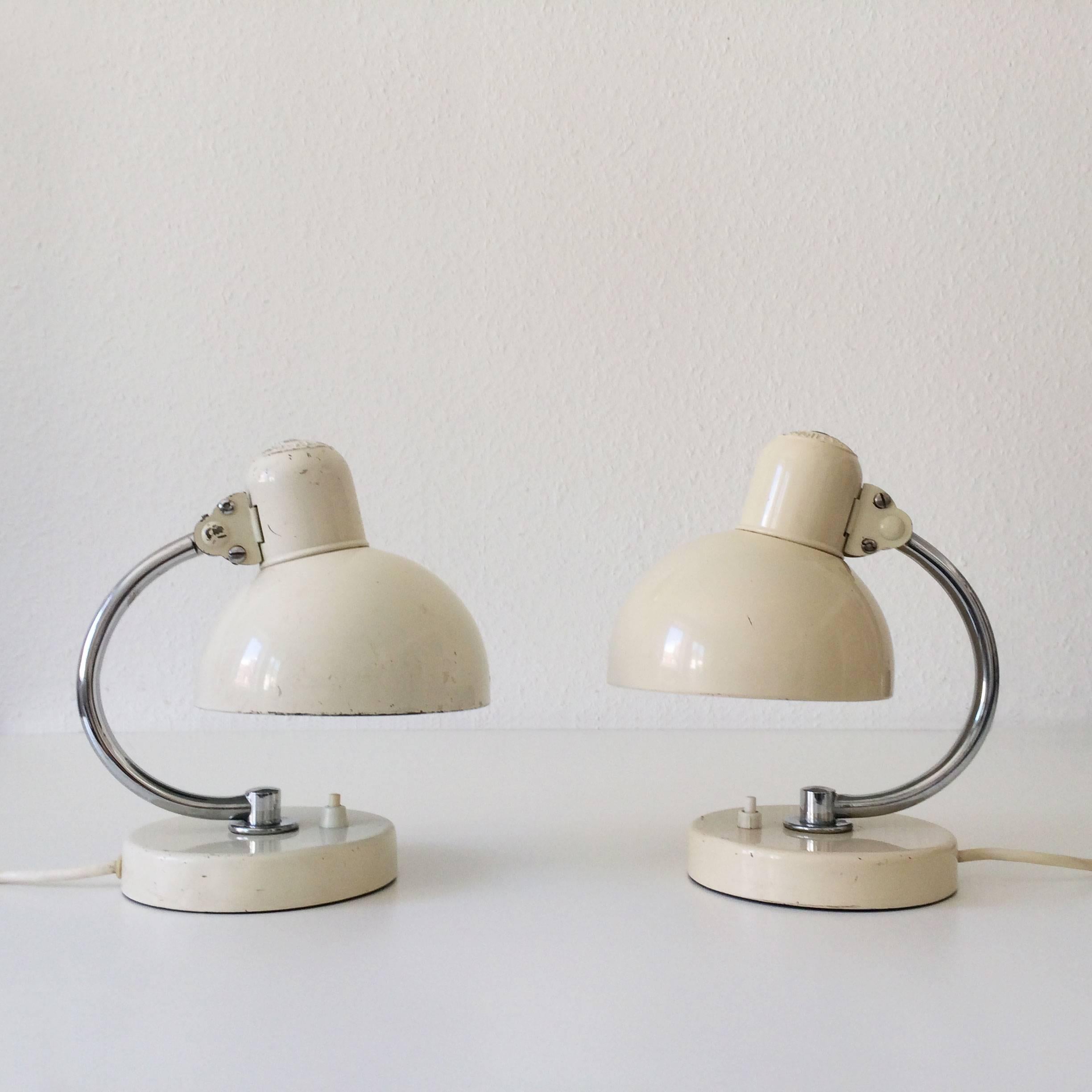 Original Bauhaus Kaiser Idell 6722 bedside table lamps, so called Baby Idell by the Bauhaus-Master Christian Dell in 1930s. Manufactured by Kaiser Leuchten, Neheim-Hüsten, Germany, 1930s. One of the lamps are in ivory, the other white lacquered.