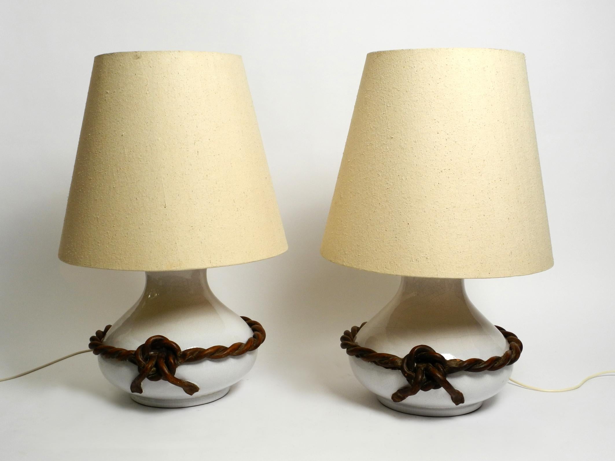 Two beautiful giant Italian midcentury white ceramic table lamps with original shades.
Great classic Italian design.
White glazed ceramic with a brown cord on the outside, also made of ceramic.
High-quality handcrafted. Wiring has been replaced